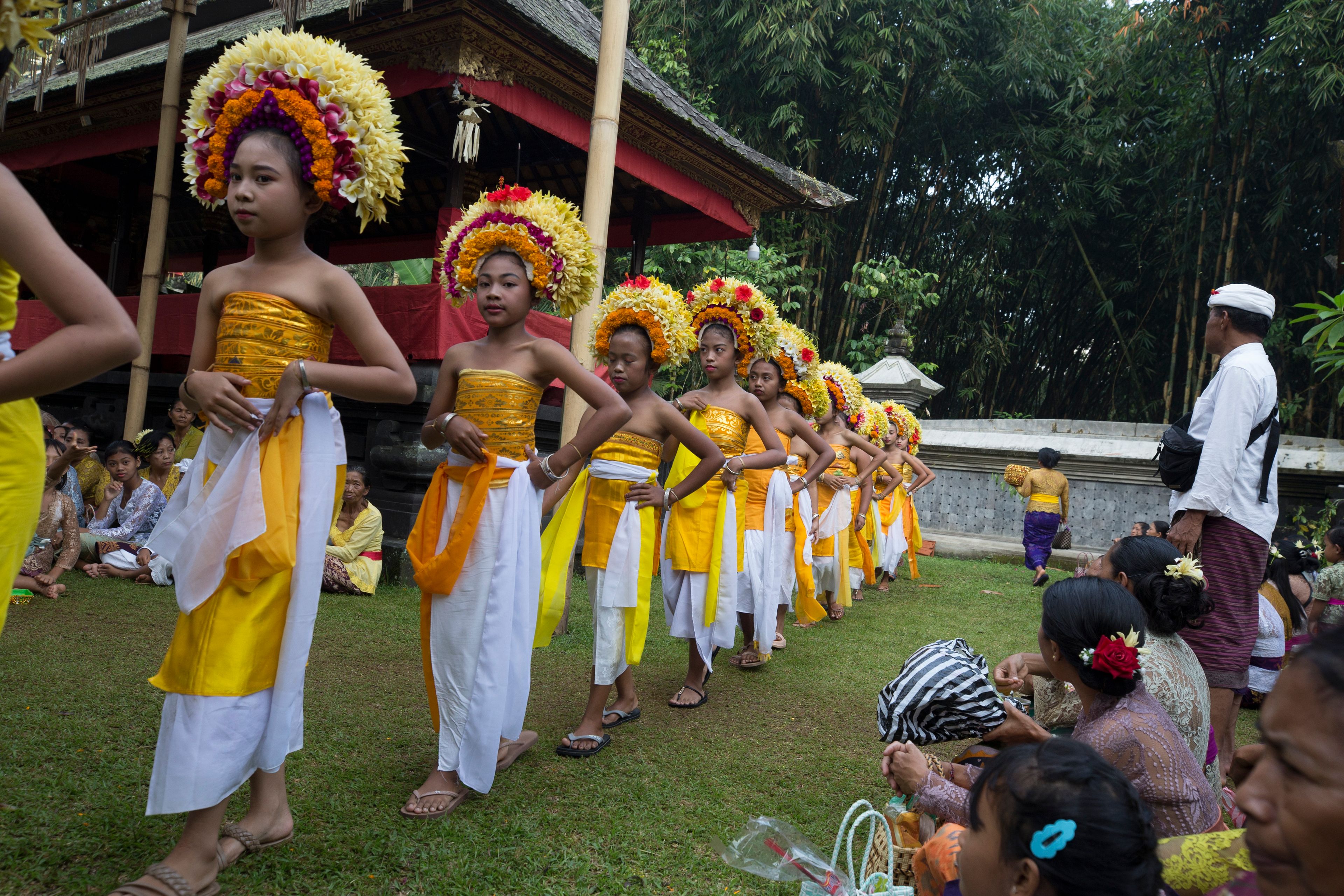 Ketut Nita Wahyuni, left, participates in Rejang Pucuk at Geriana Kauh village, Karangasem, Bali, Indonesia, Thursday, Nov. 21, 2024. (AP Photo/Firdia Lisnawati)