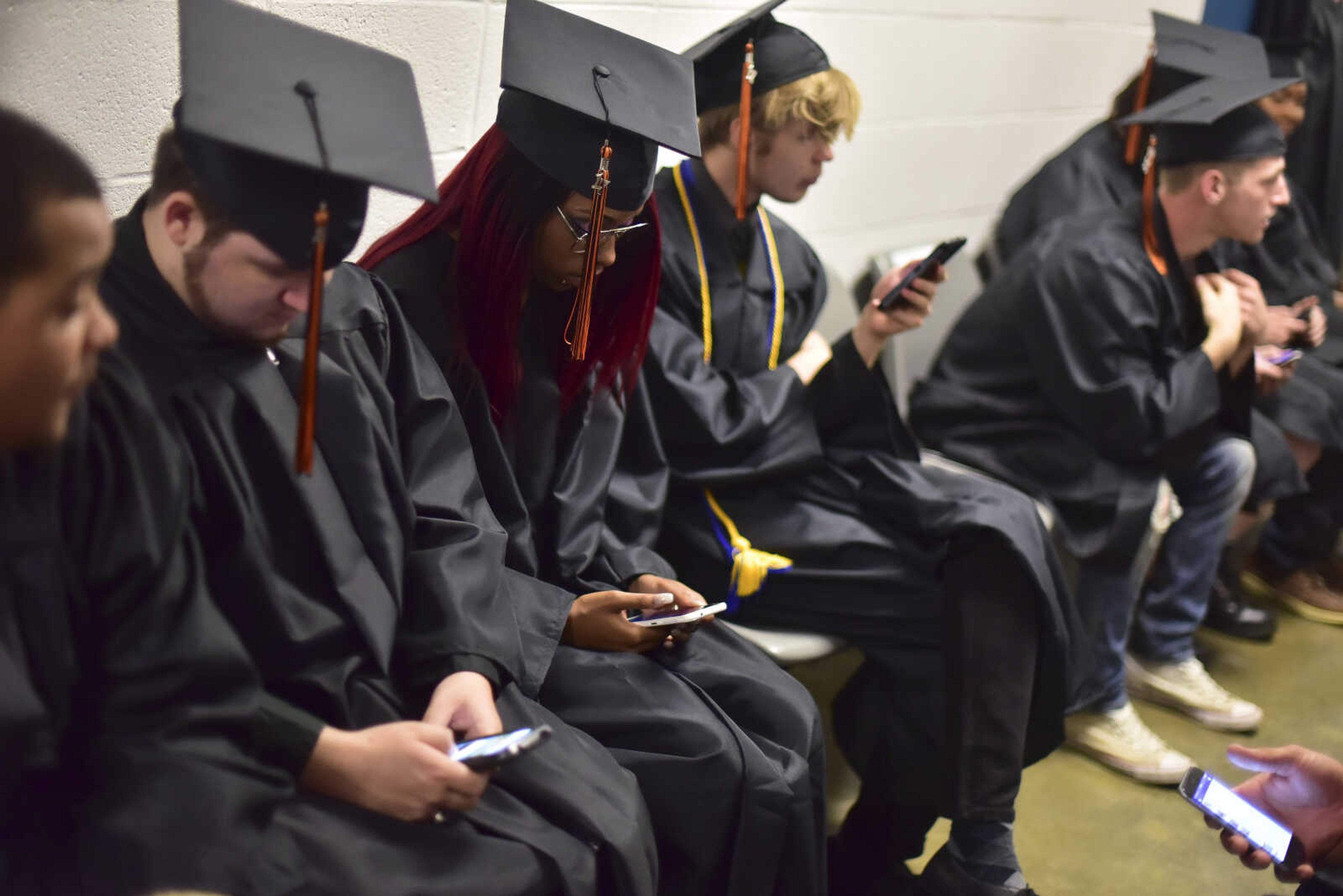 Students use their phones during Cape Girardeau Central High School graduation Sunday, May 14, 2017at the Show Me Center in Cape Girardeau.