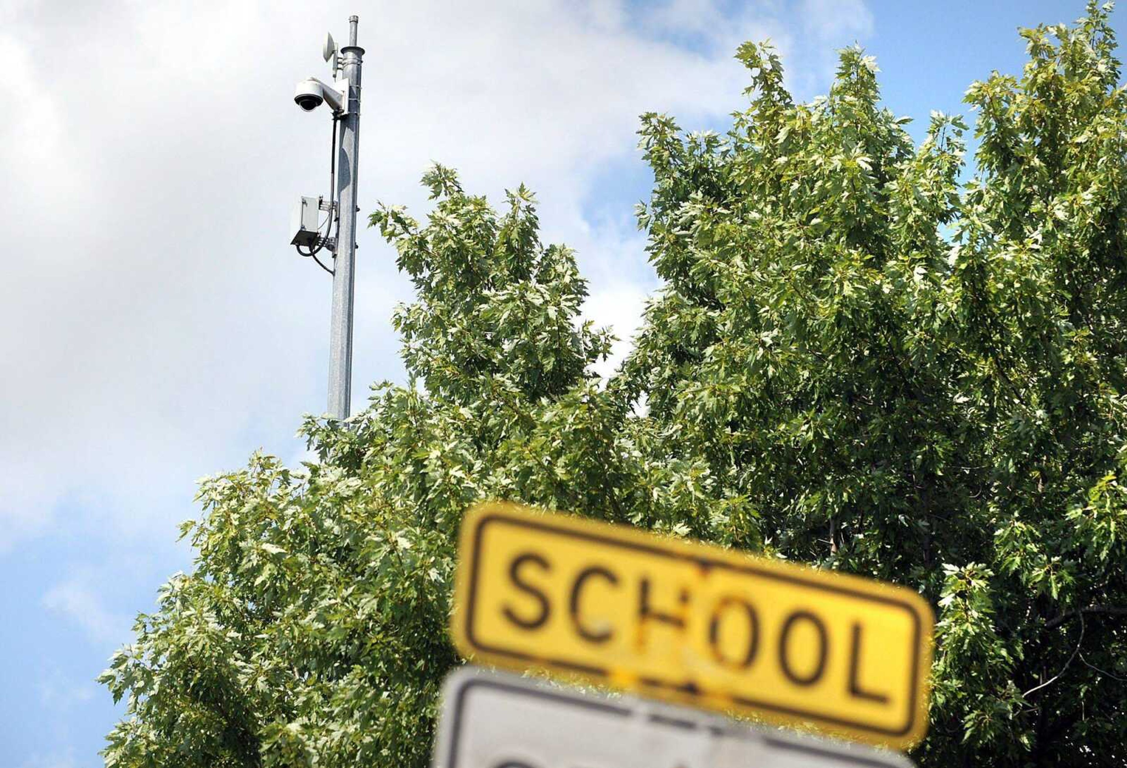 A surveillance camera hovers 60 feet from the grounds of the Virginia Pine Apartments in Sikeston, Mo. More than two dozen such cameras are sprinkled throughout the city. (Laura Simon)