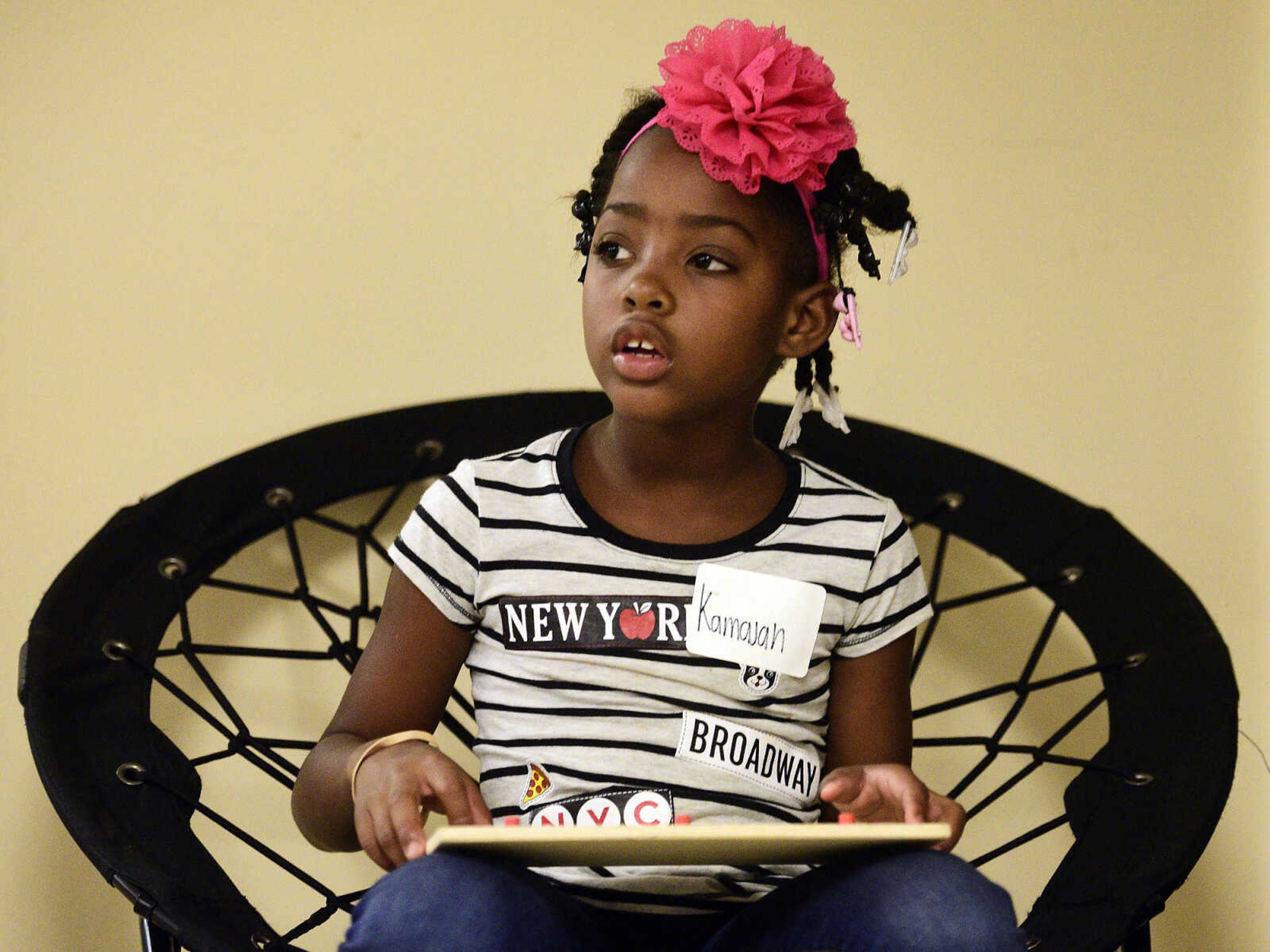 Kamajah Hamilton looks up from her puzzle on Monday, Aug. 14, 2017, during the Salvation Army's after school program at The Bridge Outreach Center in Cape Girardeau.