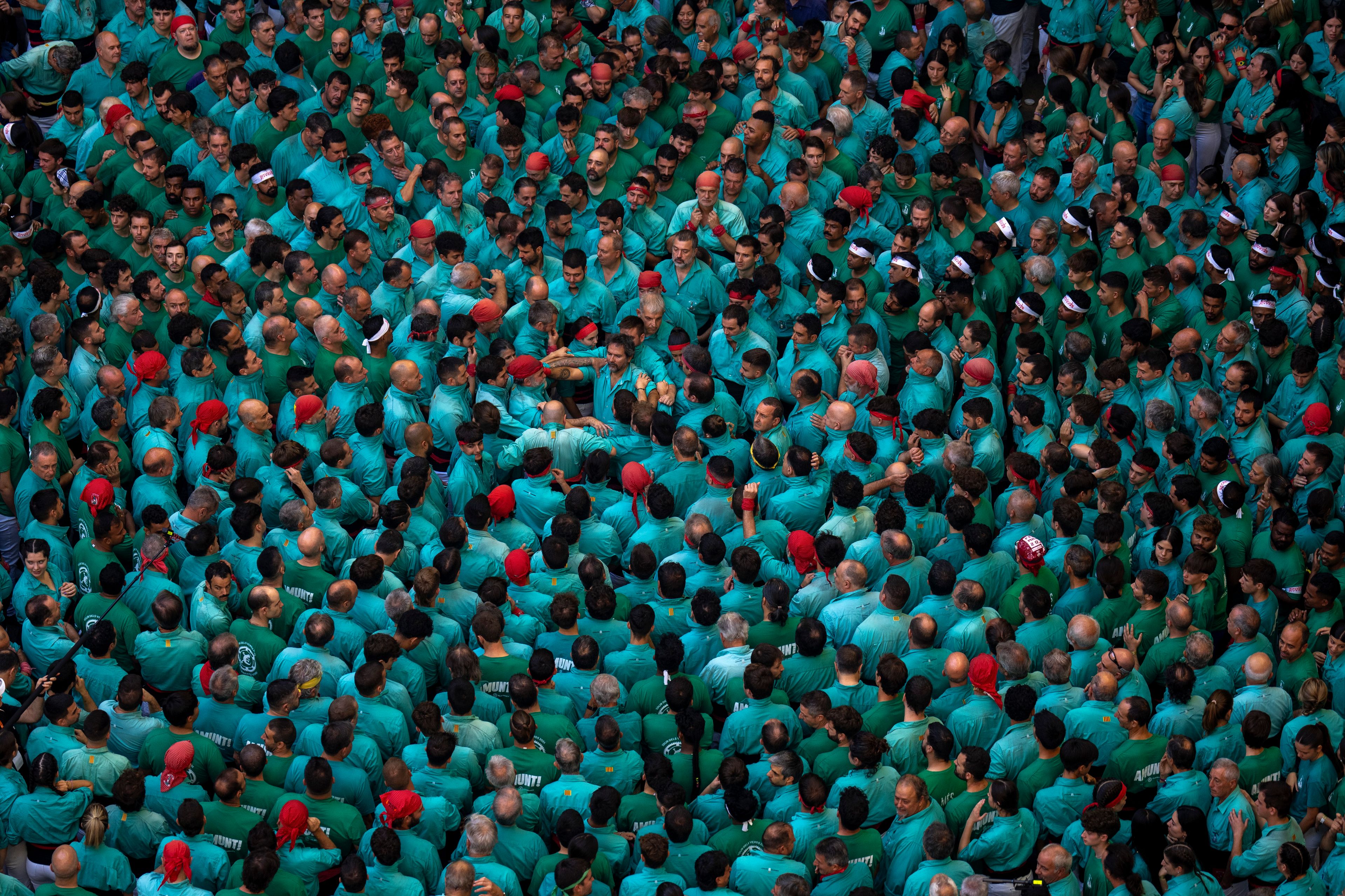 Members of "Castellers de Vilafranca" prepare to form a "Castell" or human tower, during the 29th Human Tower Competition in Tarragona, Spain, Sunday, Oct. 6, 2024. (AP Photo/Emilio Morenatti)