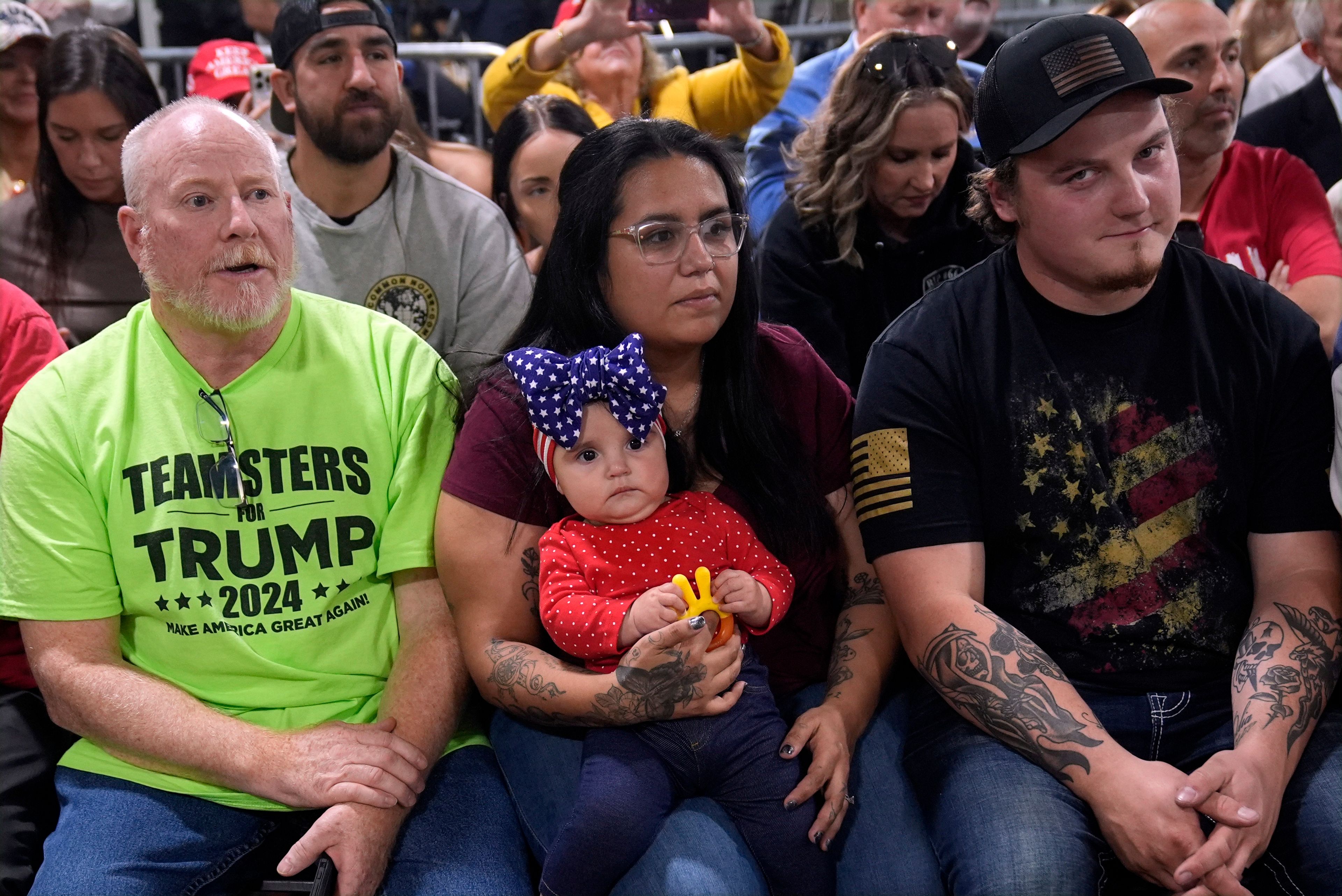 Supporters listen as Republican presidential nominee former President Donald Trump speaks at a campaign roundtable, Friday, Oct. 18, 2024, in Auburn Hills, Mich. (AP Photo/Evan Vucci)