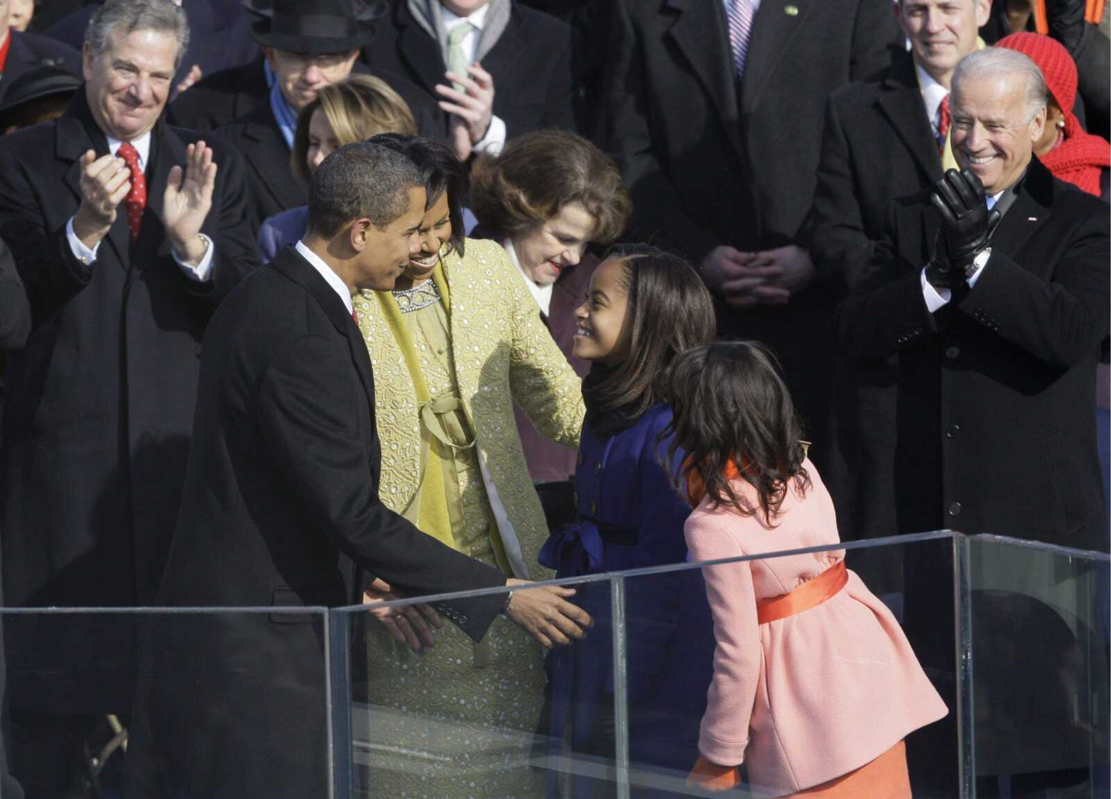 President Barack Obama, left, is congratulated by his family, first lady Michelle Obama, second from left, and daughters Malia, second from right, and Sasha following his inauguration at the U.S. Capitol in Washington, Tuesday, Jan. 20, 2009. (AP Photo/Elise Amendola)