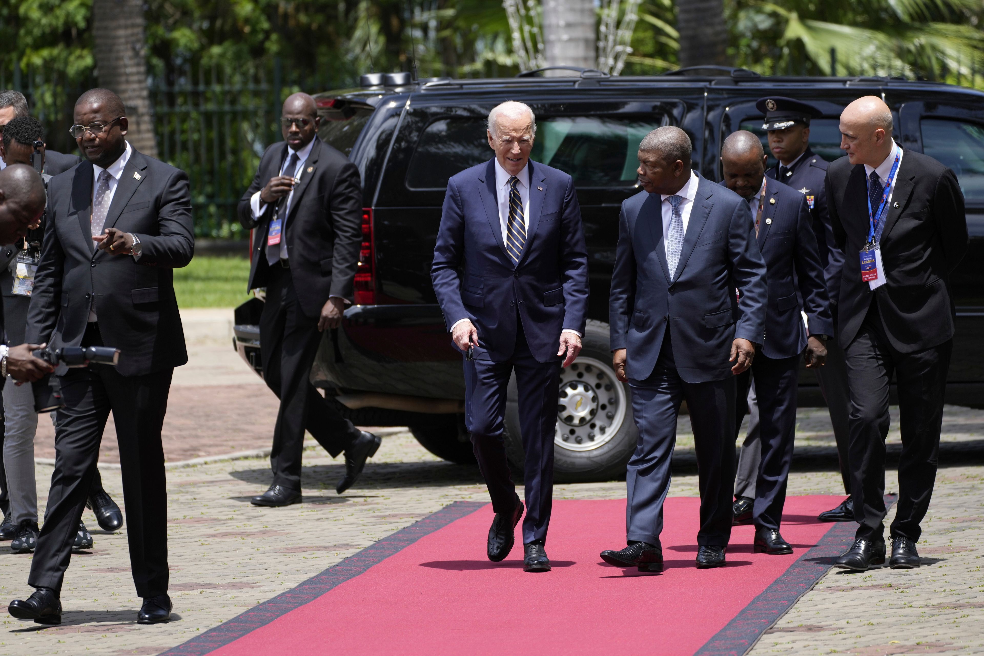 President Joe Biden walks with Angola's President Joao Lourenco, at the presidential palace in the capital Luanda, Angola on Tuesday, Dec. 3, 2024. (AP Photo/Ben Curtis)