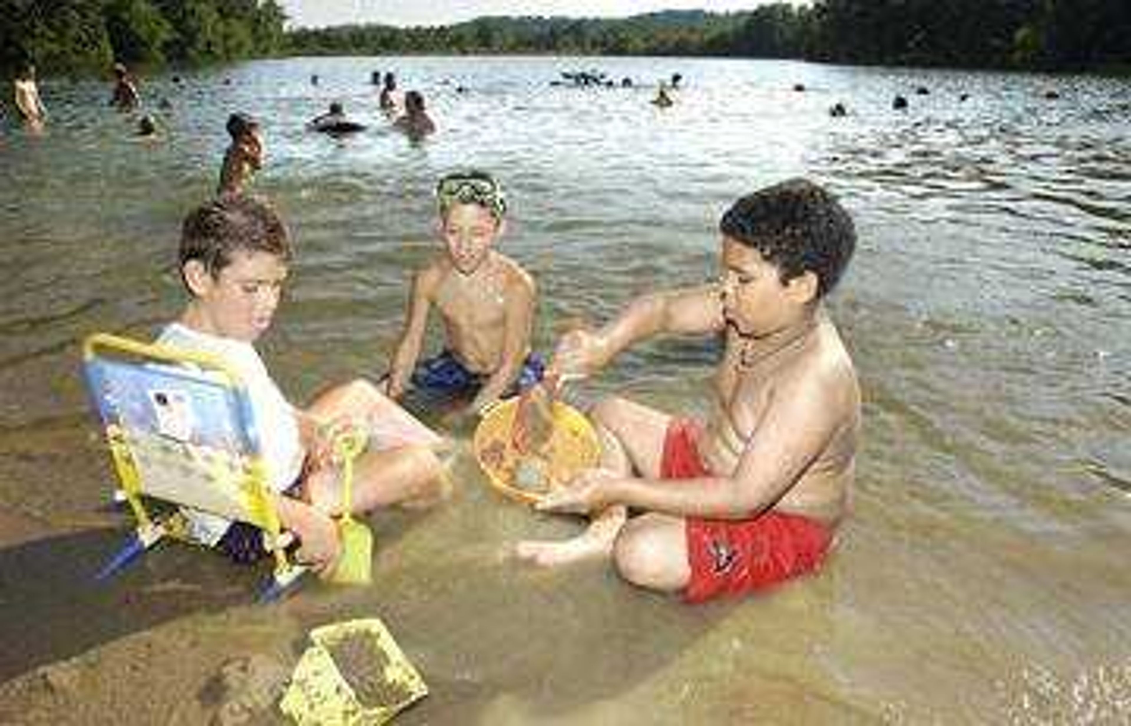 Matthew Bievenue (L), Michael Bievenue, and Doninque Jones all of Cape Girardeau spent Friday, July 4, 2003, playing in the sand and cooling off in Lake Boutin at Trail of Tears State Park.