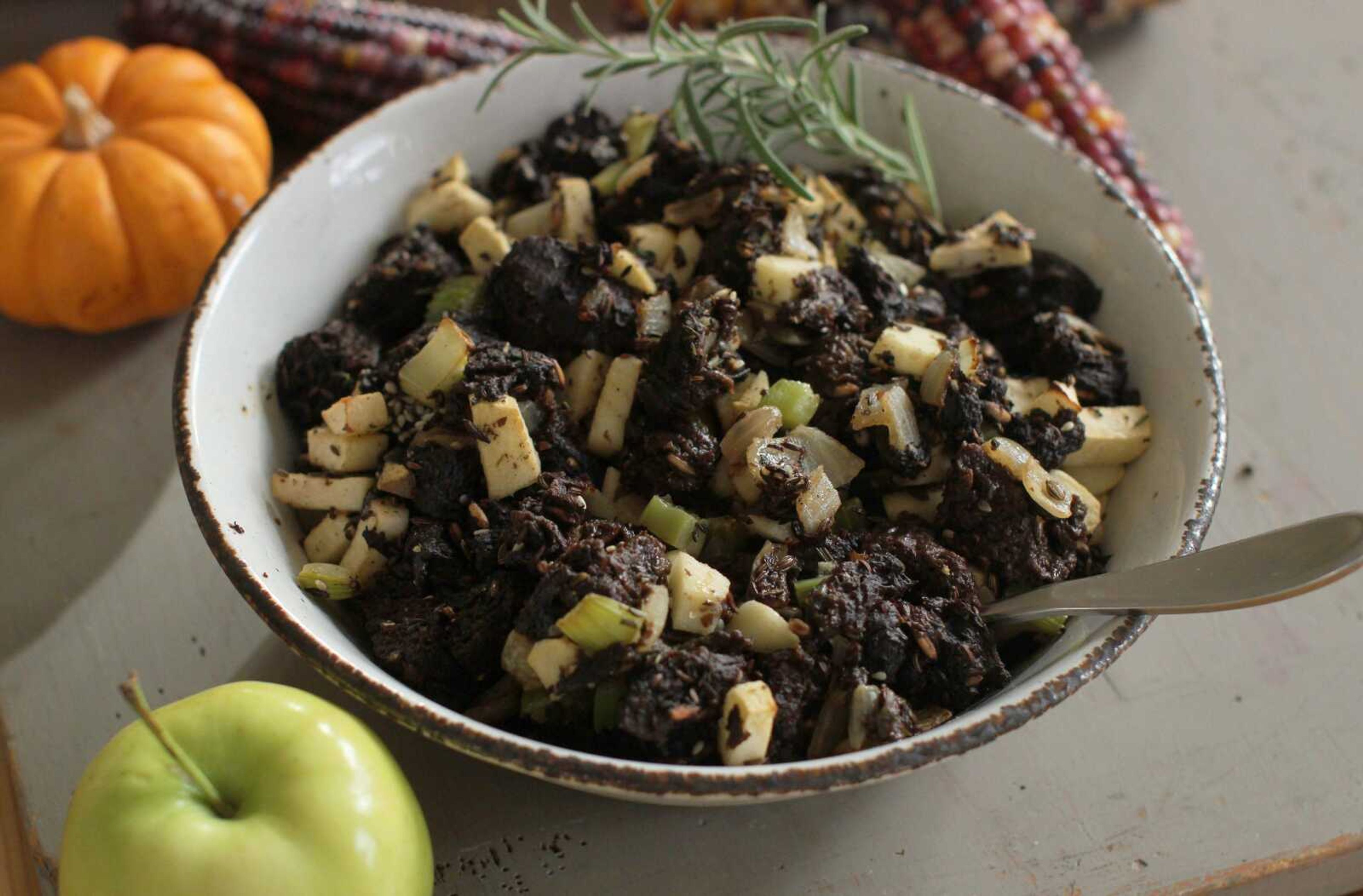 This photo shows seeded rye and apple Thanksgiving stuffing. Making one giant batch of stuffing allows for some of it to be used to stuff the turkey, while the rest can be put into a well-buttered baking dish. (AP Photo/Matthew Mead)