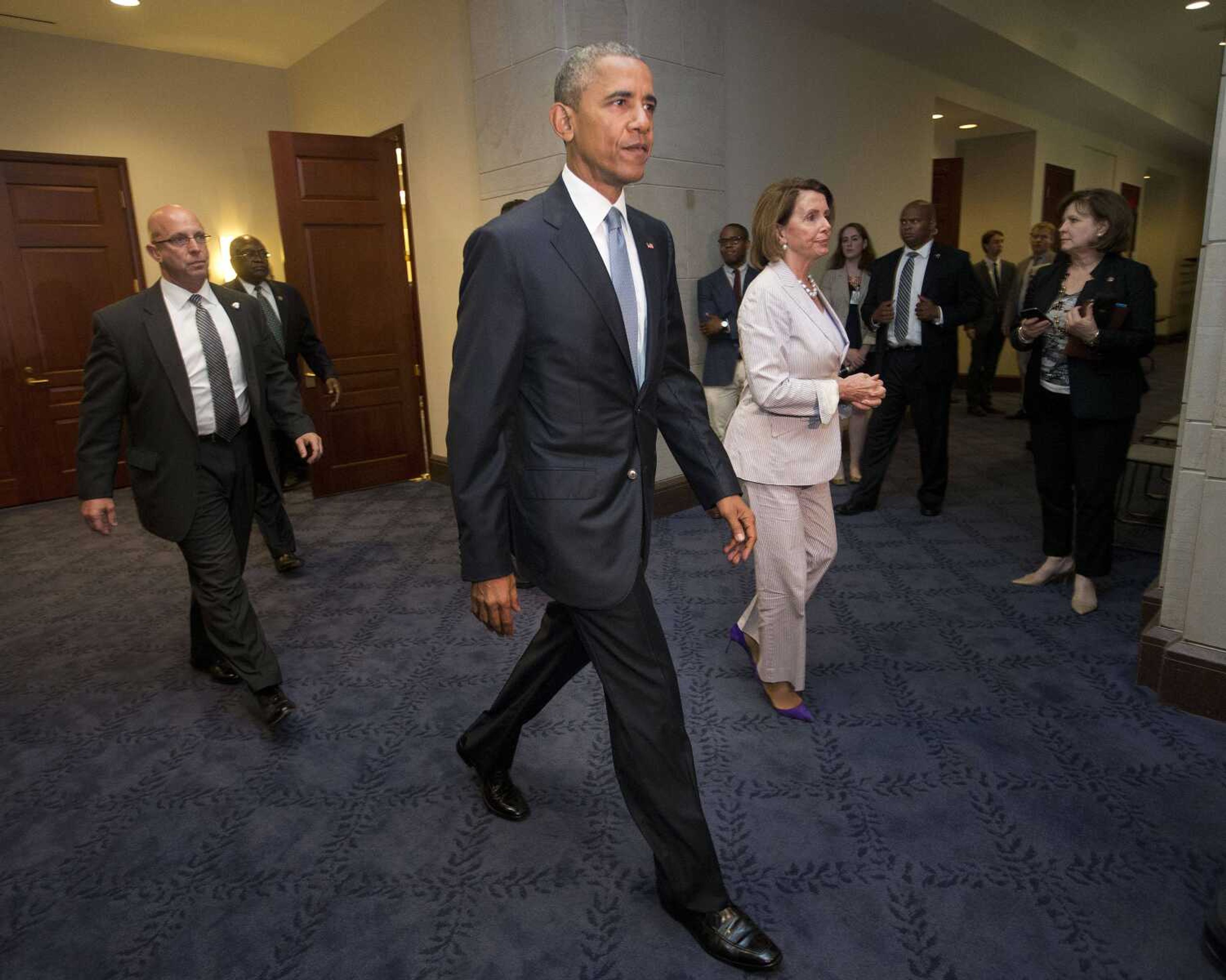 President Barack Obama and House Minority Leader Nancy Pelosi of Calif. leave meeting June 12 with House Democrats on Capitol Hill in Washington to discuss the global trade talks. The president will meet with pro-trade Democrats from Senate and House, trying to salvage trade agenda. (Pablo Martinez Monsivais ~ Associated Press)