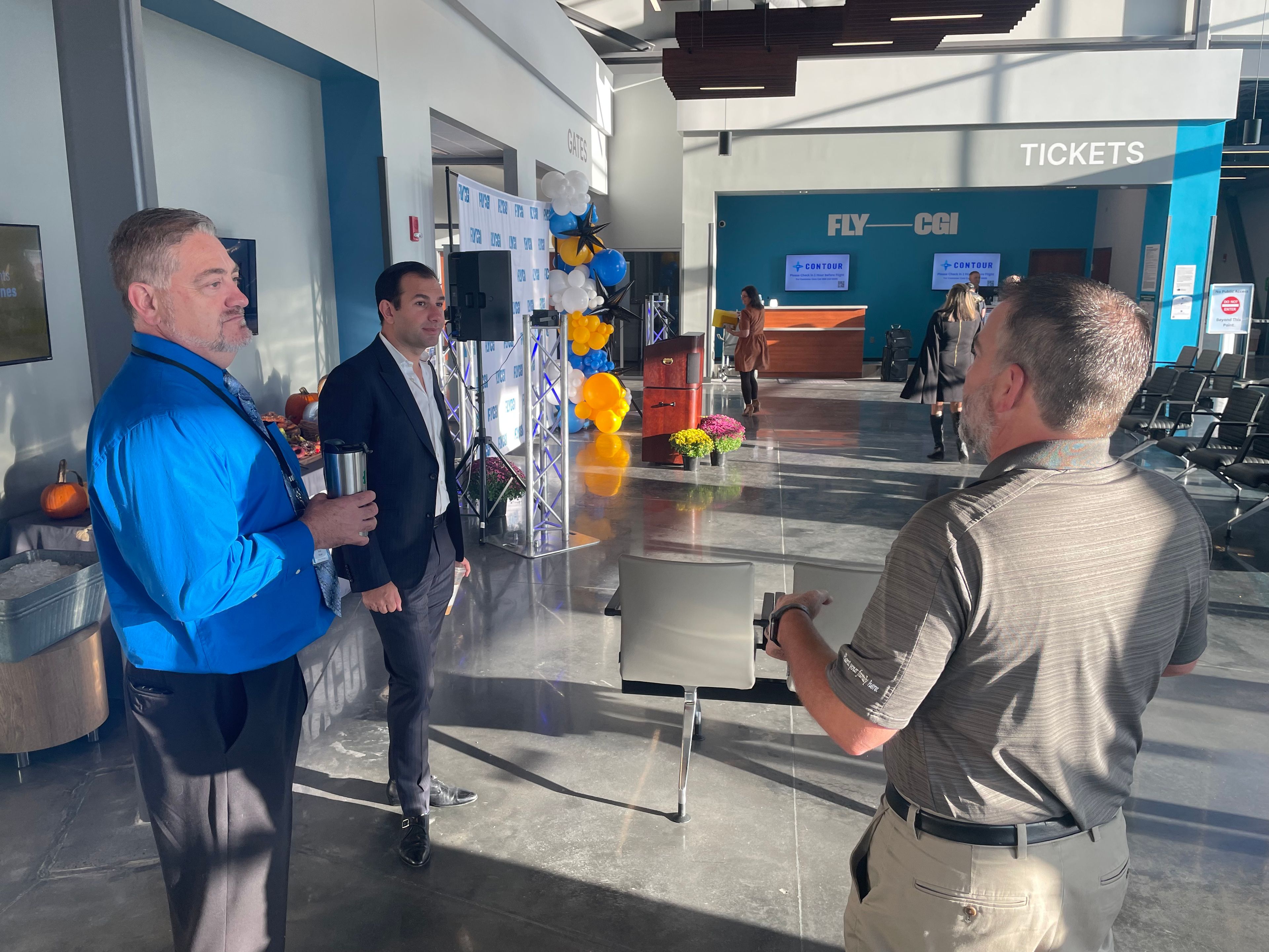 Newly appointed Airport Manager JoJo Stuart, on left, talks to Perryville City Administrator Brent Buerck as Contour Airlines CEO Matt Chaifetz looks on.