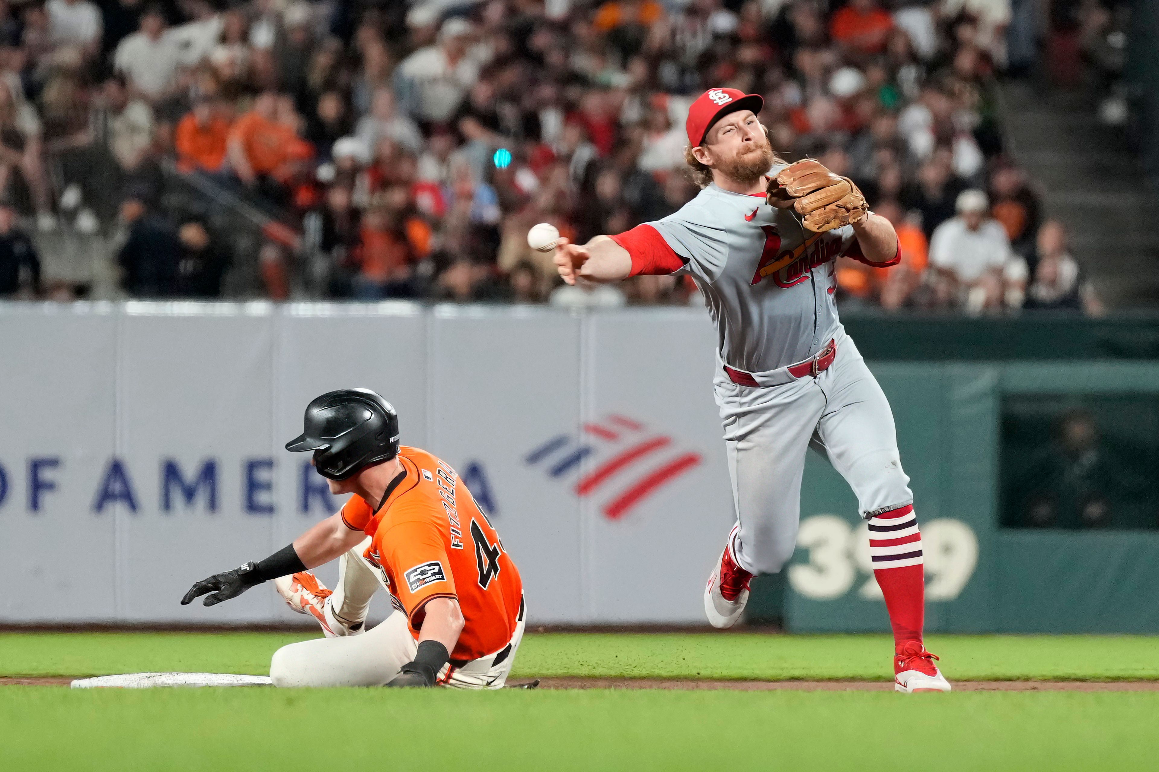 St. Louis Cardinals second baseman Brendan Donovan, right, gets a force out against San Francisco Giants' Tyler Fitzgerald, left, at second base and turns a double play on a ball hit by Giants' Casey Schmitt during the sixth inning of a baseball game Friday, Sept. 27, 2024, in San Francisco. (AP Photo/Tony Avelar)