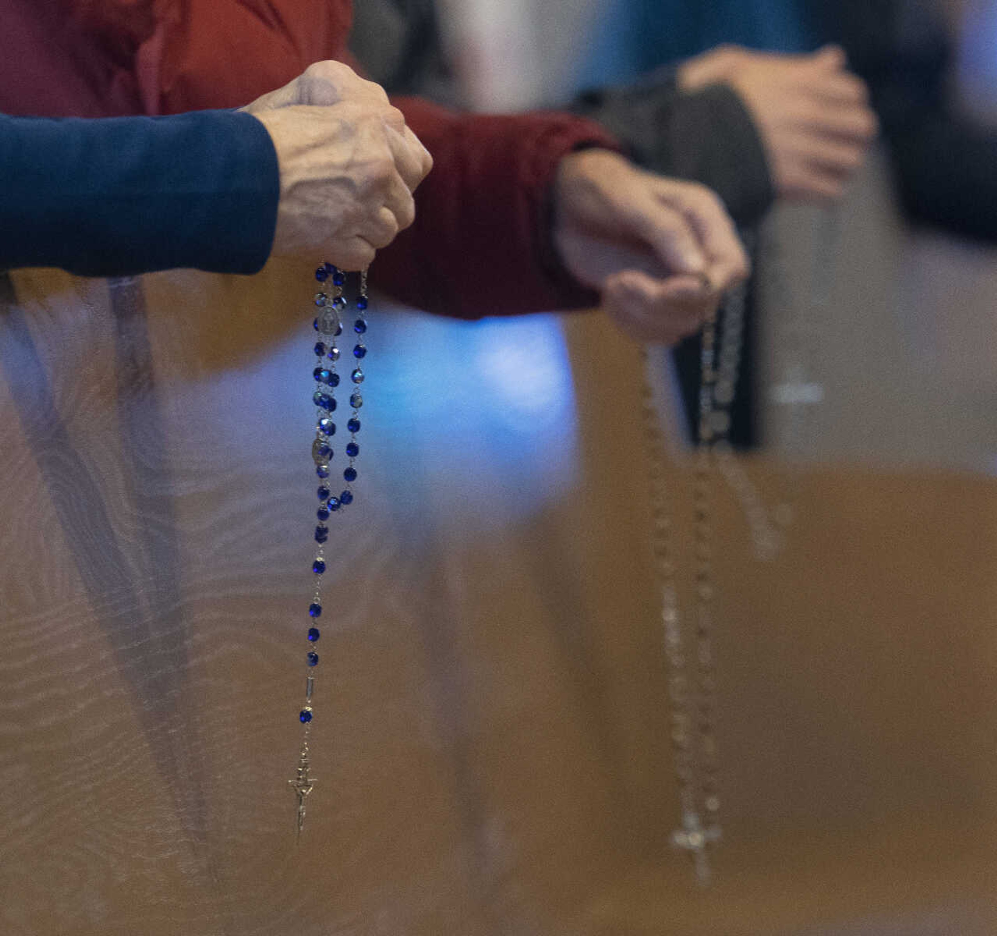 Rosary beads are seen as people take part in a group Rosary prayer before the march portion of a March for Life on Saturday, Jan. 18, 2020, at Immaculate Conception Catholic Church in Jackson.