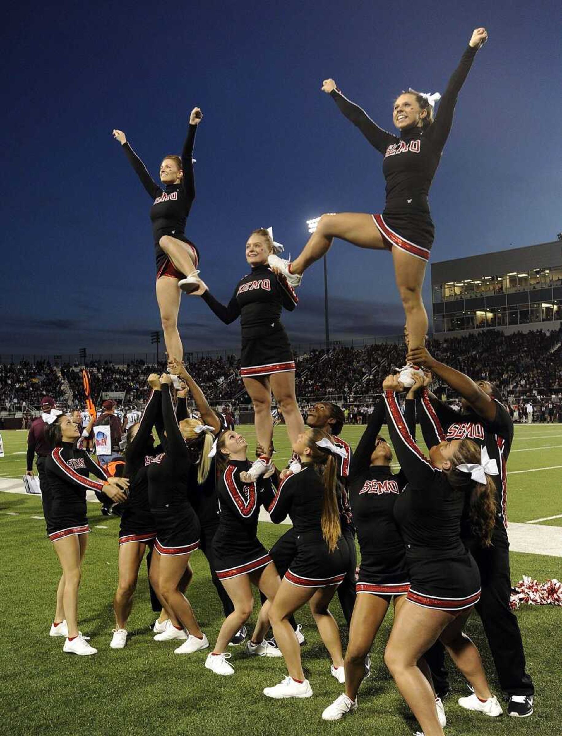 The Southeast Missouri State cheerleaders perform for Redhawks fans at the Southern Illinois football game Saturday, Sept. 13, 2014 in Carbondale, Ill.