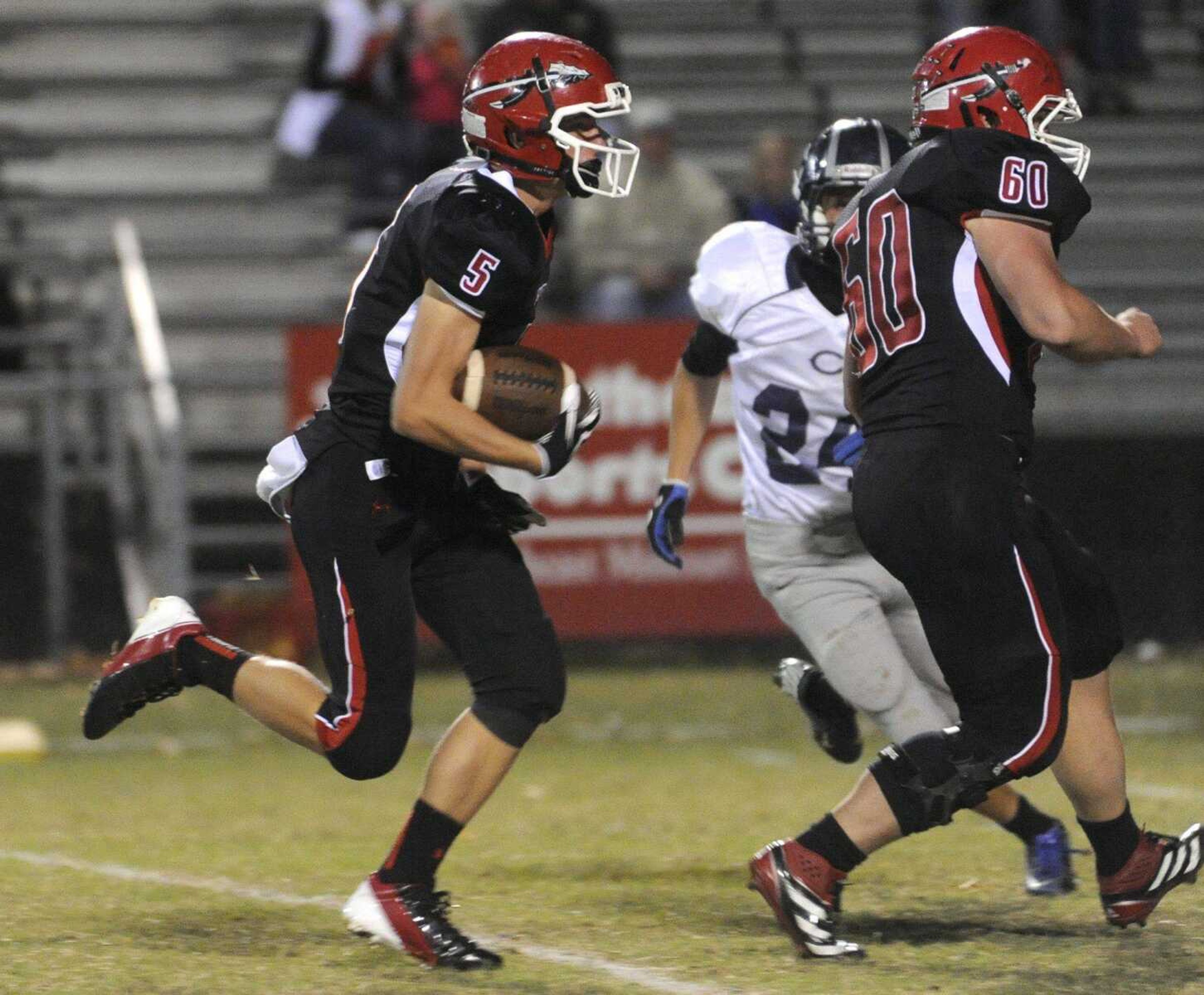 Jackson's Taylor Henson carries the ball behind Nick Keser against Francis Howell Central during the second quarter Friday, Oct. 19, 2012 in Jackson. (Fred Lynch)