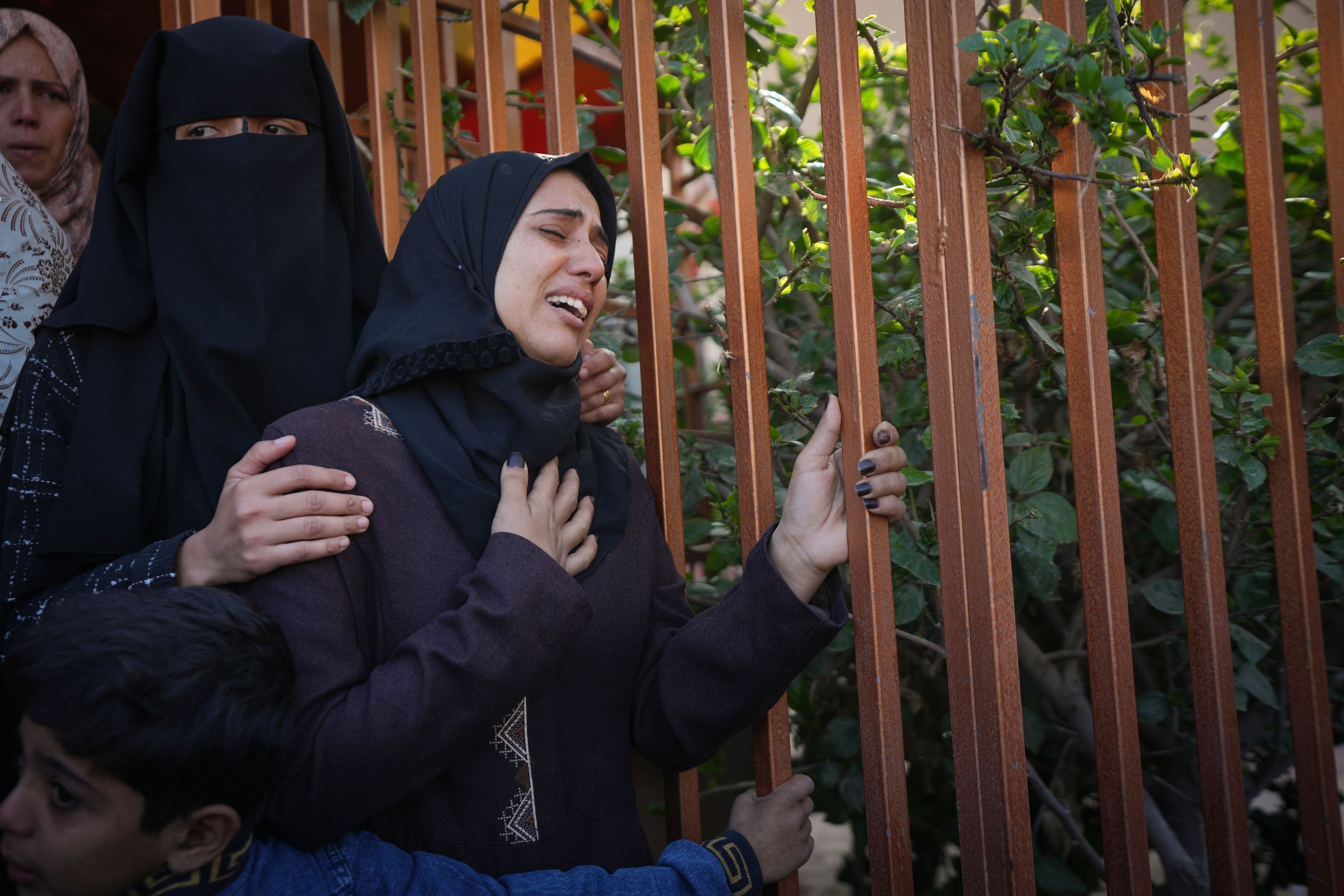 A woman weeps during the funeral of the victims of an Israeli army airstrike in Khan Younis, Gaza Strip, Thursday Nov. 21, 2024. Palestinian health officials say the death toll in the Gaza Strip from the 13-month-old war between Israel and Hamas has surpassed 44,000. (AP Photo/Abdel Kareem Hana)