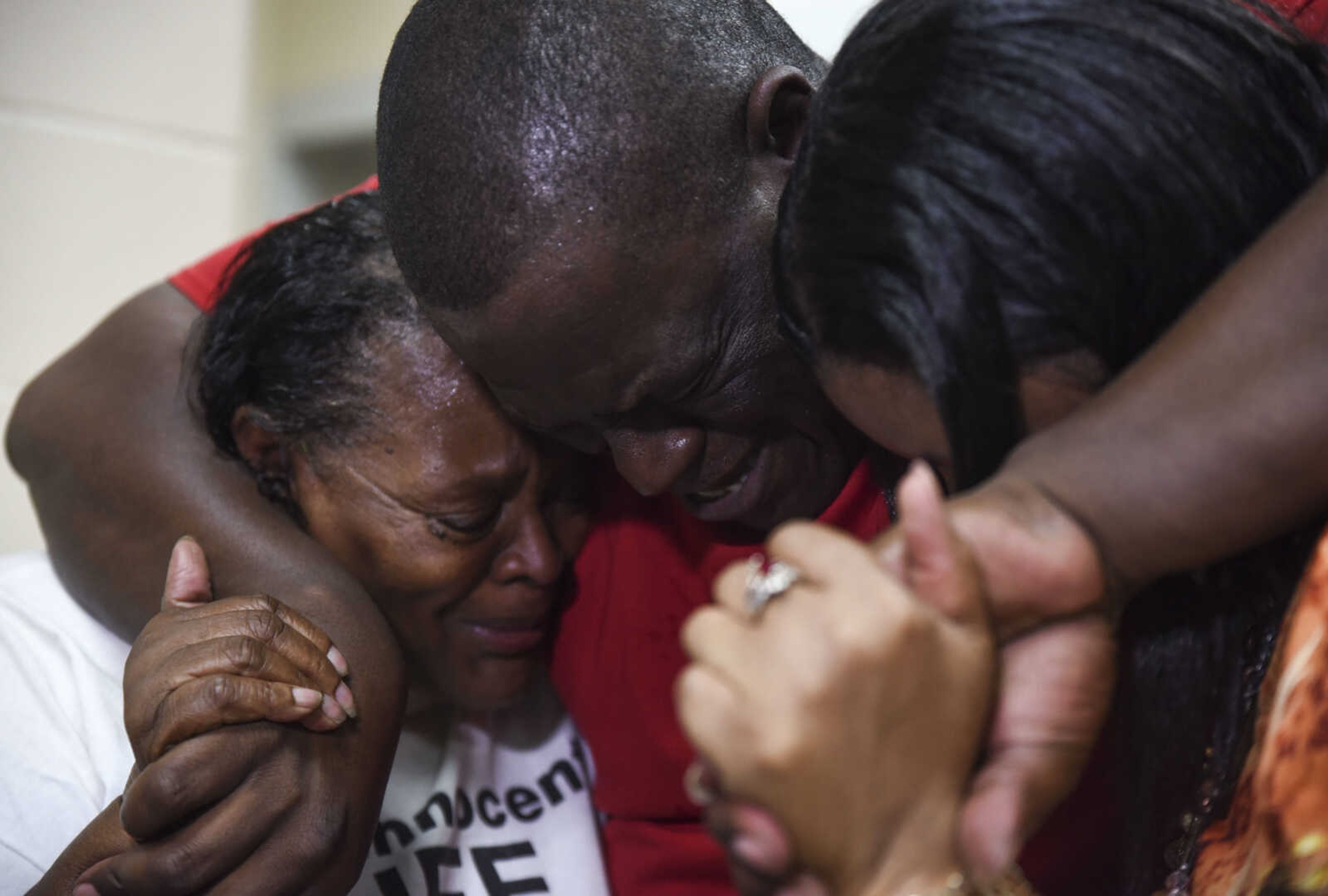 From left, Jennett McCaster, David Robinson and Pat Jackson embrace after Robinson's release from the Jefferson City Correctional facility Monday, May 14, 2018 in Jefferson City.