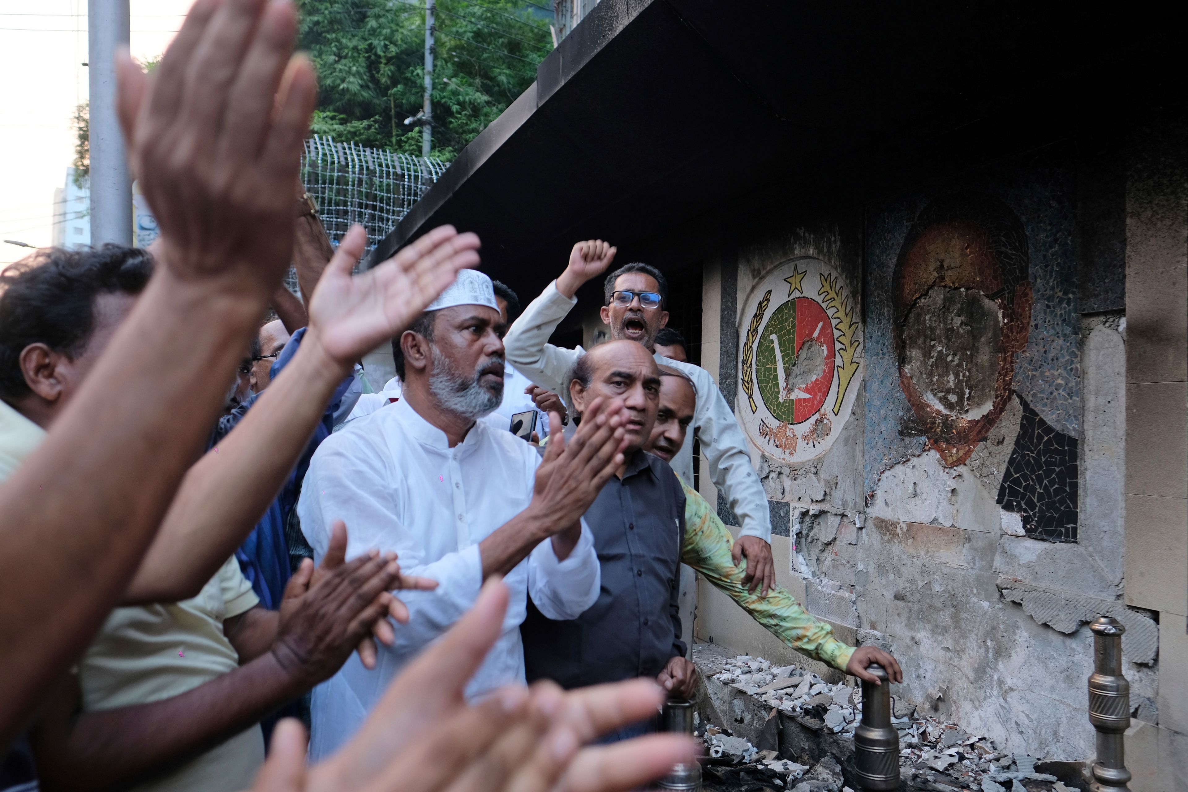 Supporters of the Jatiya Party that supports the country's ousted leader Sheikh Hasina, protest outside a vandalised party office, in Dhaka, Bangladesh, Friday, Nov. 1, 2024. (AP Photo/Mahmud Hossain Opu)