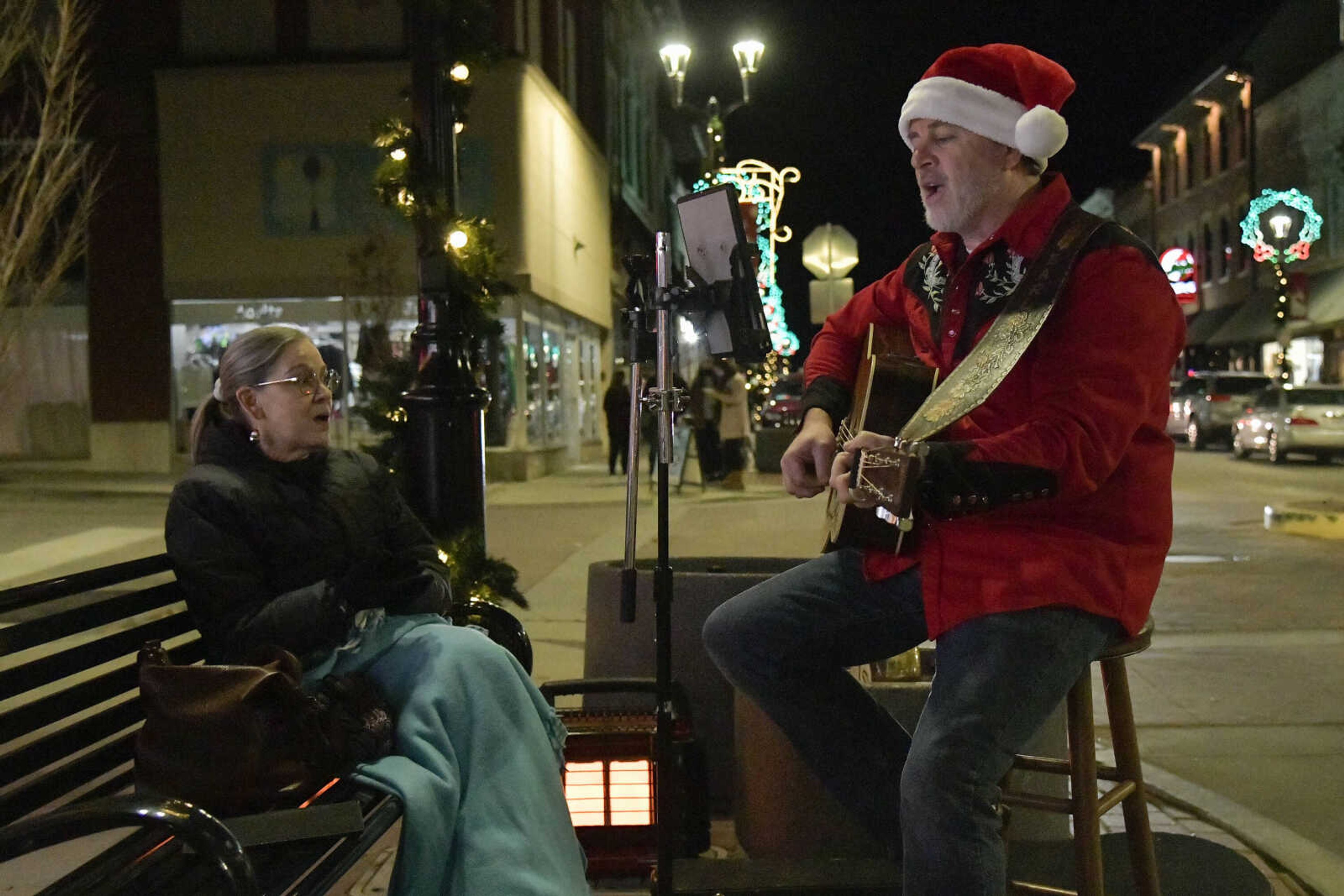 (From left) Kim and Earl Bennett sing "Santa Claus is Coming to Town" during the Downtown Christmas Open House in Cape Girardeau on Friday, Dec. 4, 2020.