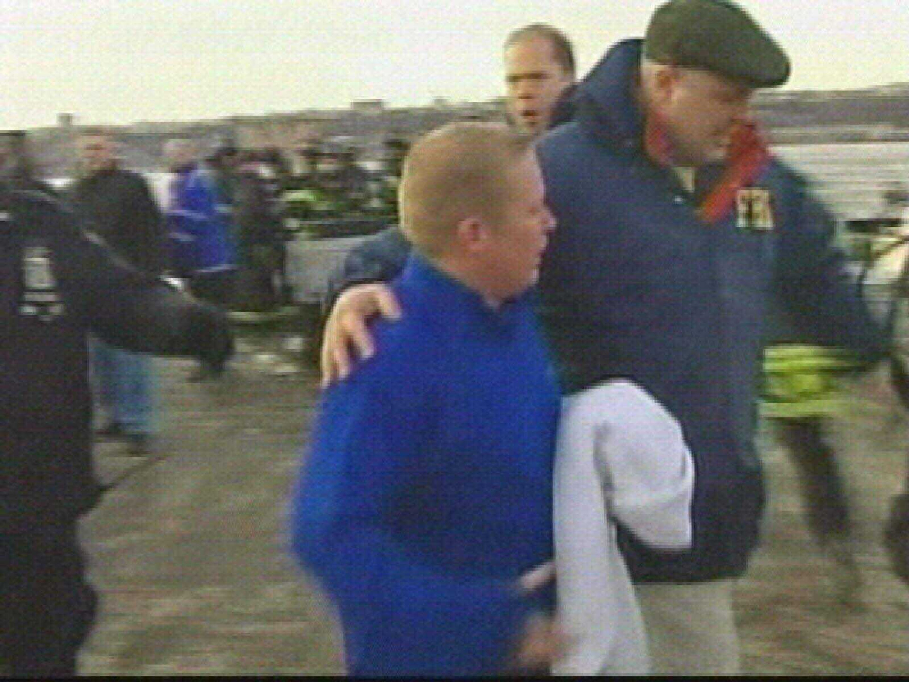 This video frame grab image taken from AP Television News shows a passenger who was rescued from a US Airways aircraft that has gone down in the Hudson River in New York being escorted by law enforcement personnel, Thursday Jan. 15, 2009. The Airbus 320 crashed into the frigid Hudson River on Thursday afternoon after a collision with a flock of birds disabled both its engines, sending more than 150 passengers and crew members scrambling onto rescue boats, authorities say. No deaths or serious injuries were immediately reported. (AP Photo/APTN)