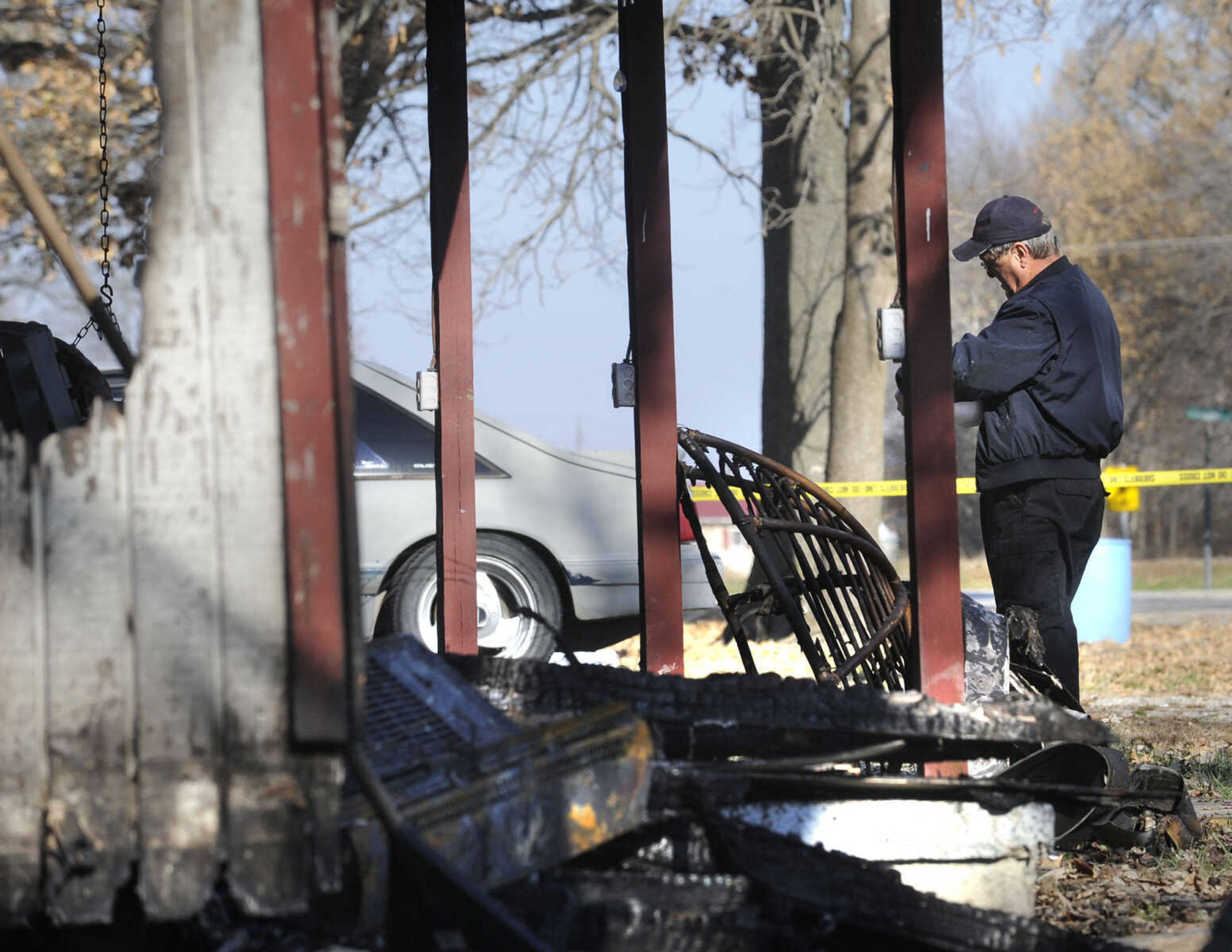 Butch Amann, an investigator with the Missouri Division of Fire Safety, checks the scene of a mobile home fire Friday, Nov. 29, 2013 at 466 Penny St. in Allenville. (Fred Lynch)