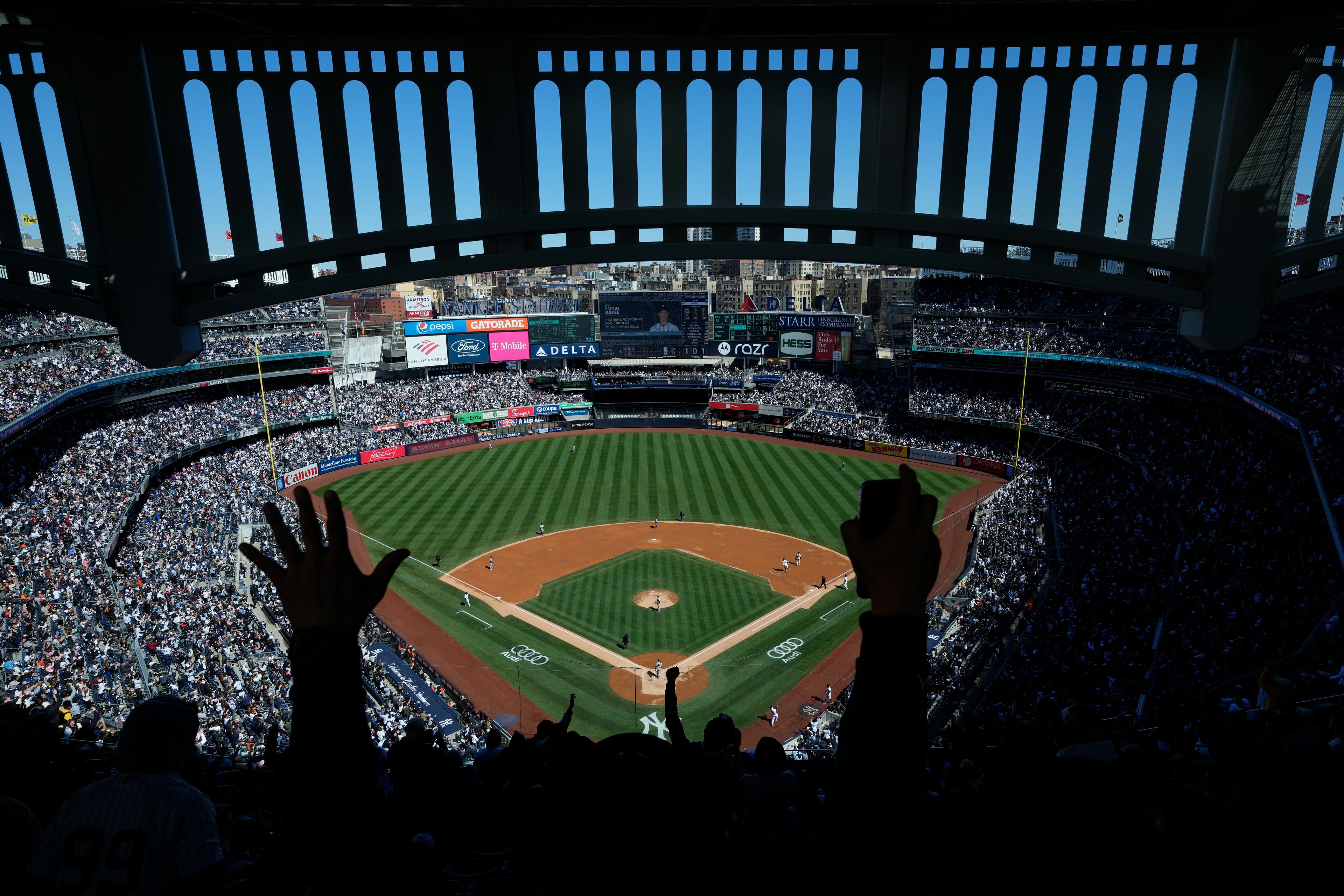 FILE - Fans react after New York Yankees' Aaron Judge hits a home run during the third inning of a baseball game against the San Francisco Giants at Yankee Stadium, Sunday, April 2, 2023, in New York. (AP Photo/Seth Wenig, File)