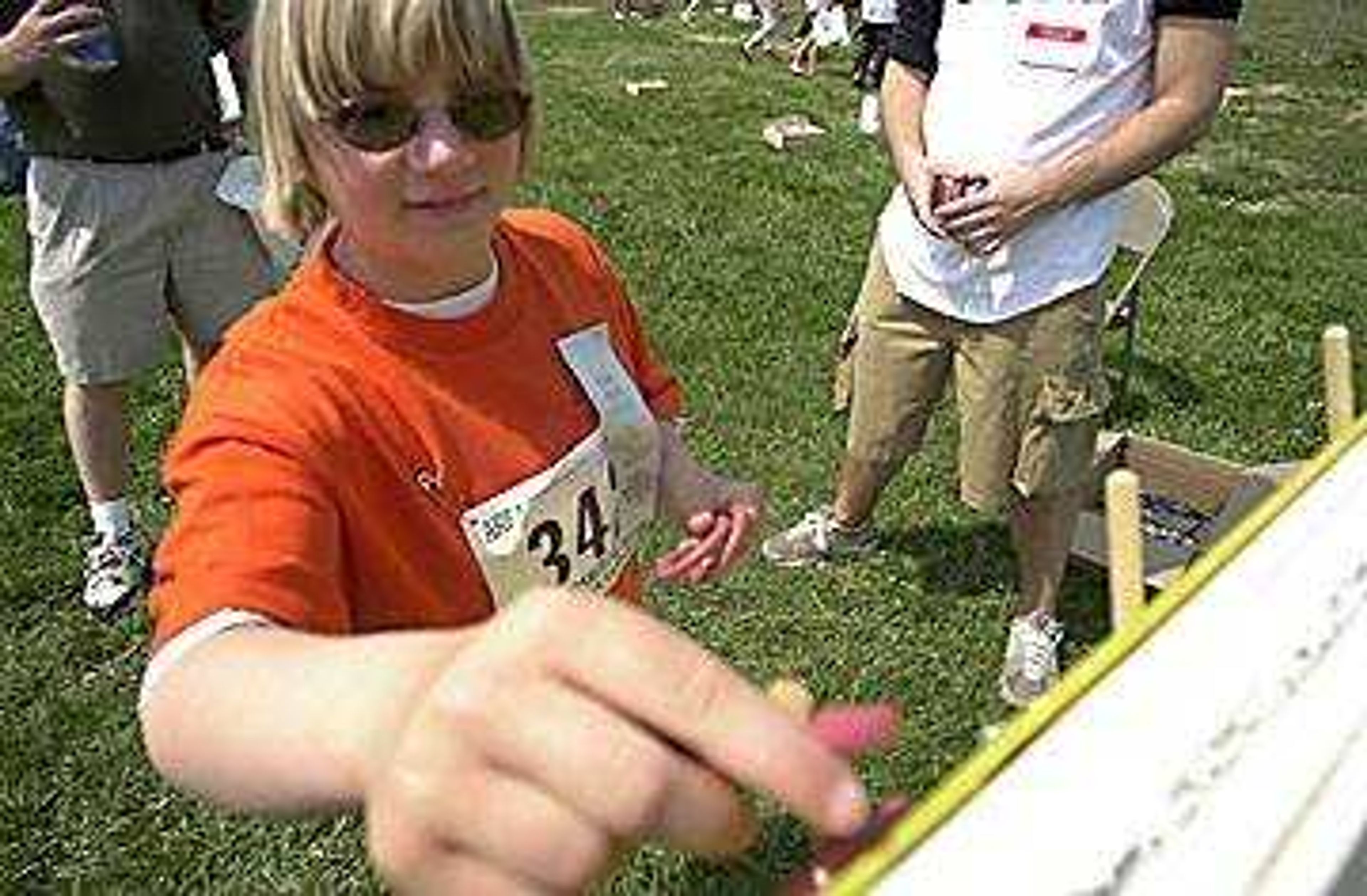 Sixth grader Lisa Bailey gently placed her rings on the spokes of the Ring Toss board.