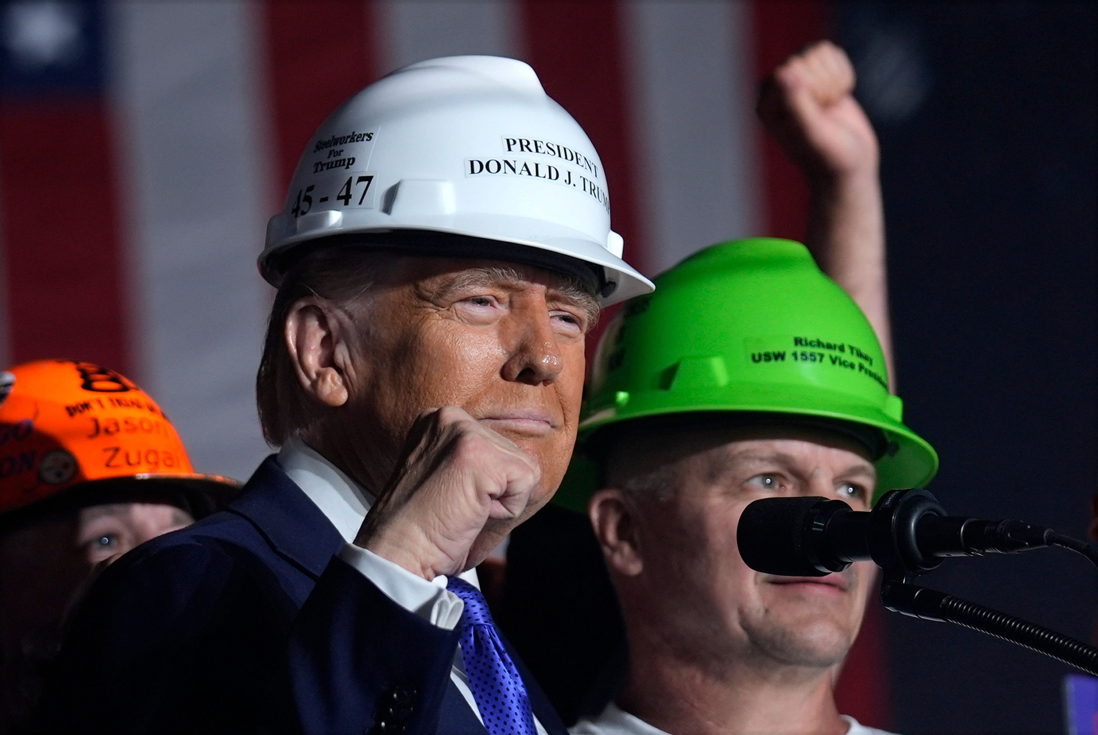 Republican presidential nominee former President Donald Trump stands on stage with steelworkers as he speaks at a campaign rally, Saturday, Oct. 19, 2024, at Arnold Palmer Regional Airport in Latrobe, Pa. (AP Photo/Evan Vucci)