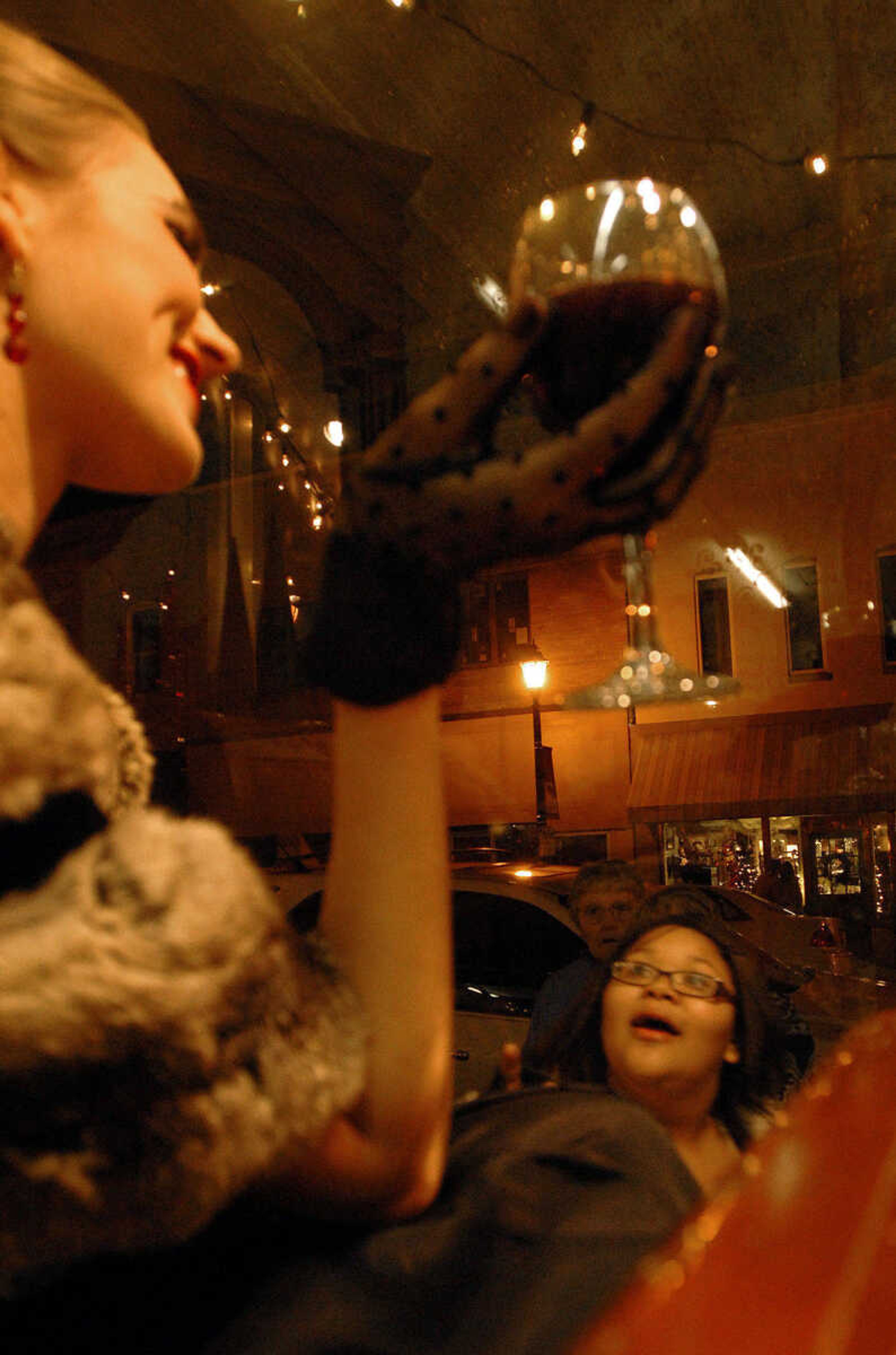 LAURA SIMON ~ lsimon@semissourian.com
Passers by are take back by the live models posing as mannequins in the storefront of Pastimes Antiques Friday, Dec. 2, 2011 during Old Town Cape's annual Downtown Christmas Open House.