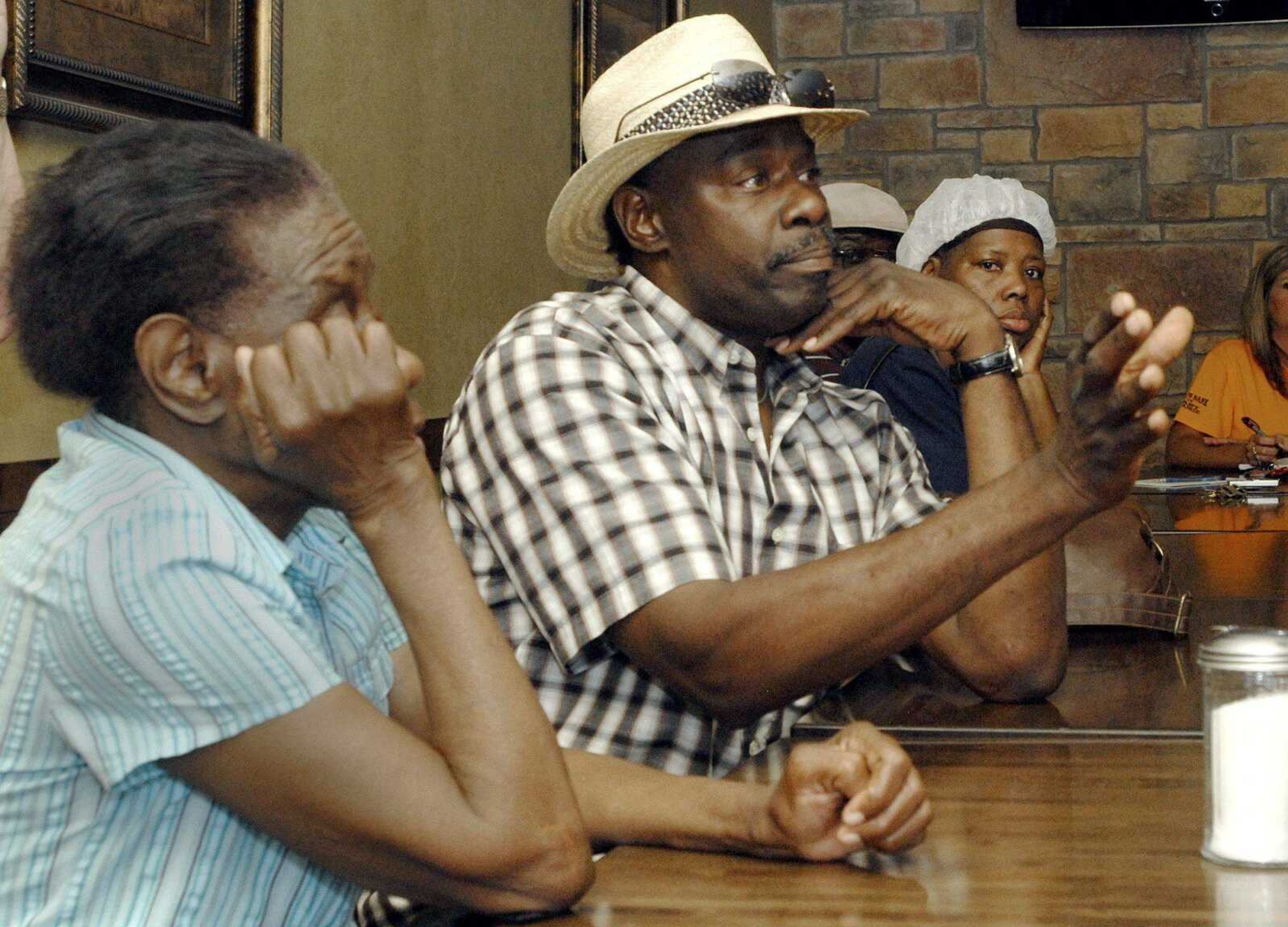 Hattie Lee Garrison, left, and Bernice Johnson listen as Joe Brown voices his concerns on the future of Pinhook, Mo. to a room full of fellow Pinhook residents Wednesday, June 1, 2011 at Boomland in Charleston. Residents met there to voice their concerns and hear possible options on the future of Pinhook. (Laura Simon)