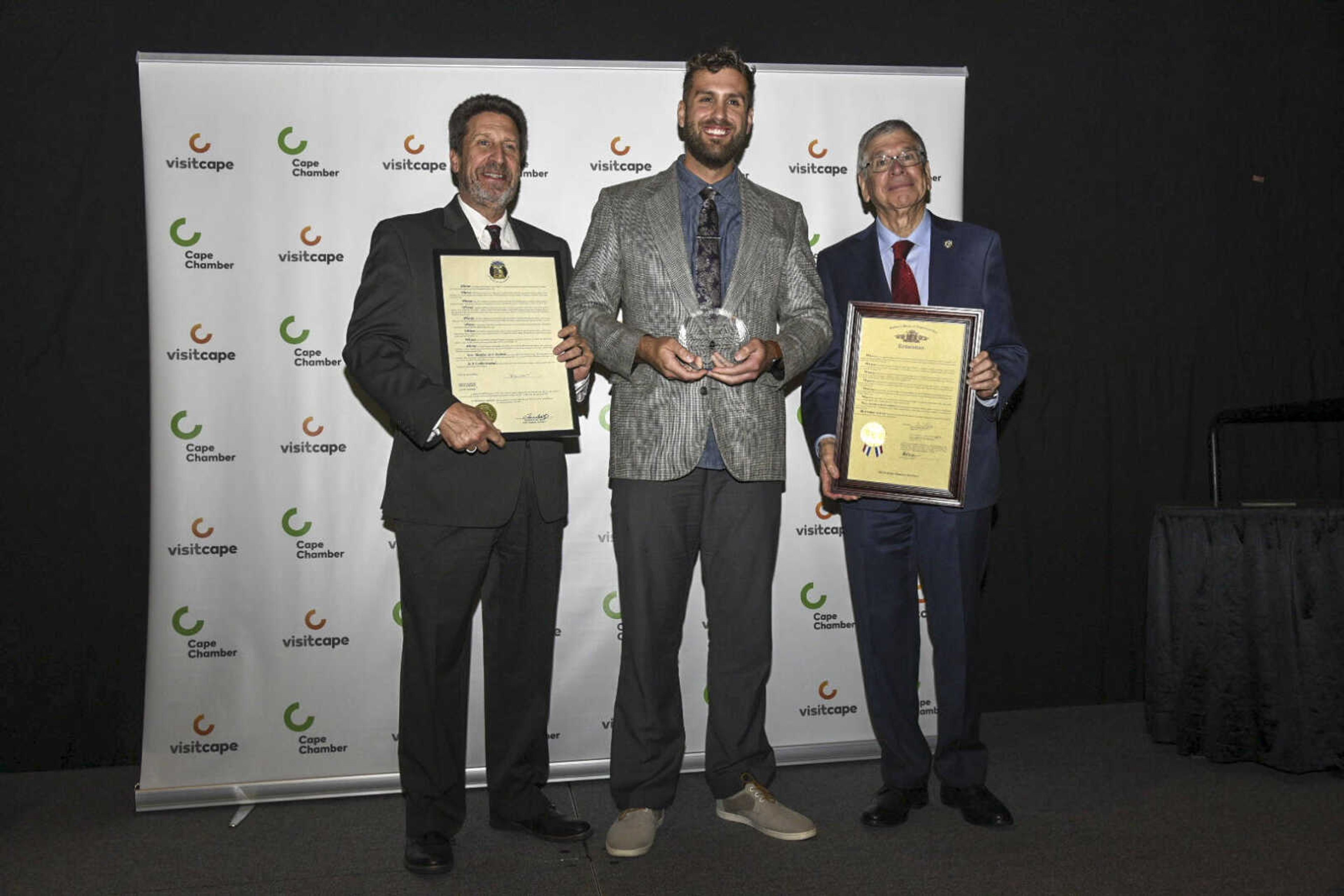 Nate Gautier, center, accepts the Ambassador of the Year Award during the 2021 Annual Cape Chamber Dinner Thursday, Oct. 21, at the Show Me Center in Cape Girardeau.