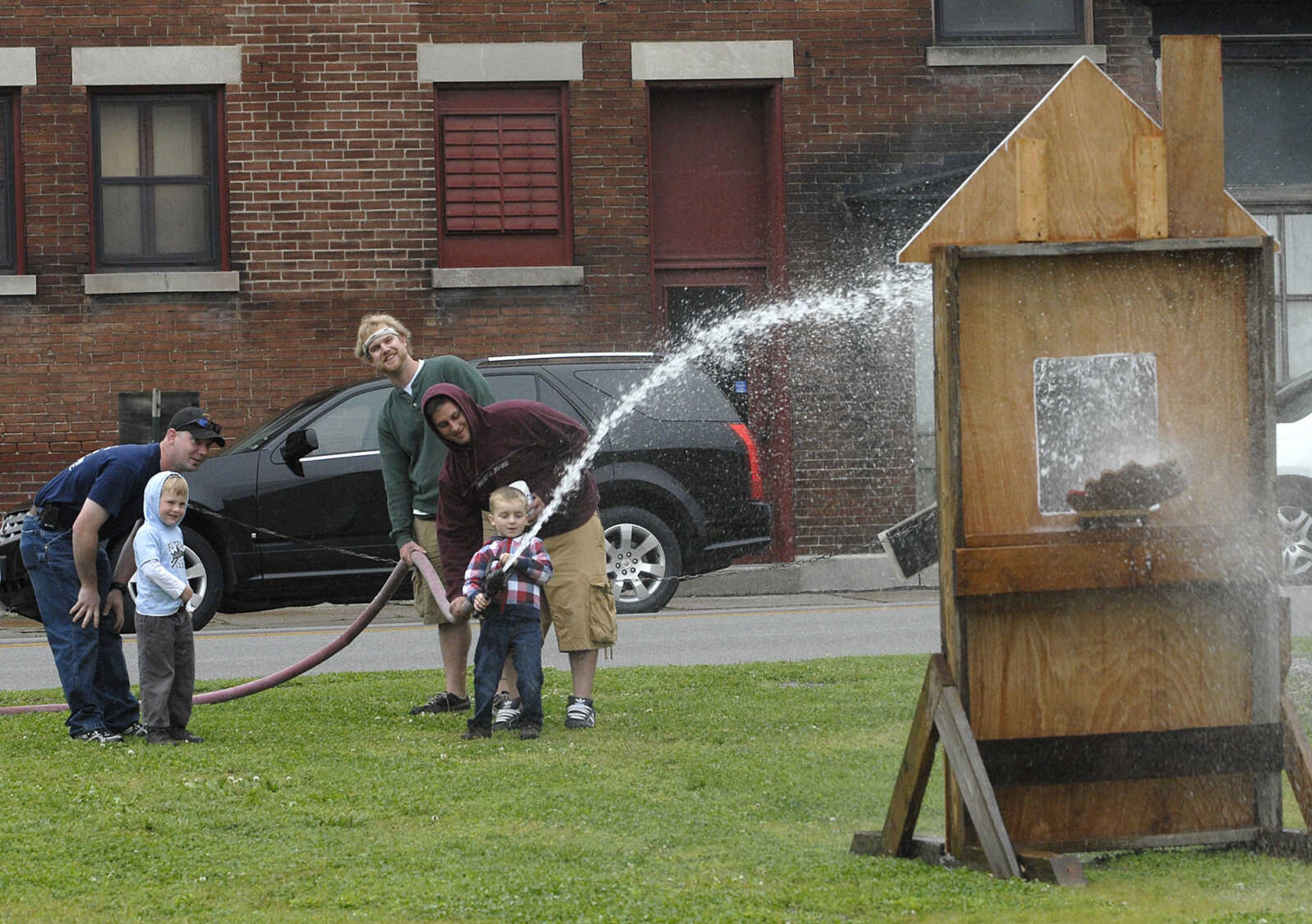 Collier Howard, 5, tries out the water hose at the Cape Girardeau Fire Department's 100th anniversary event.