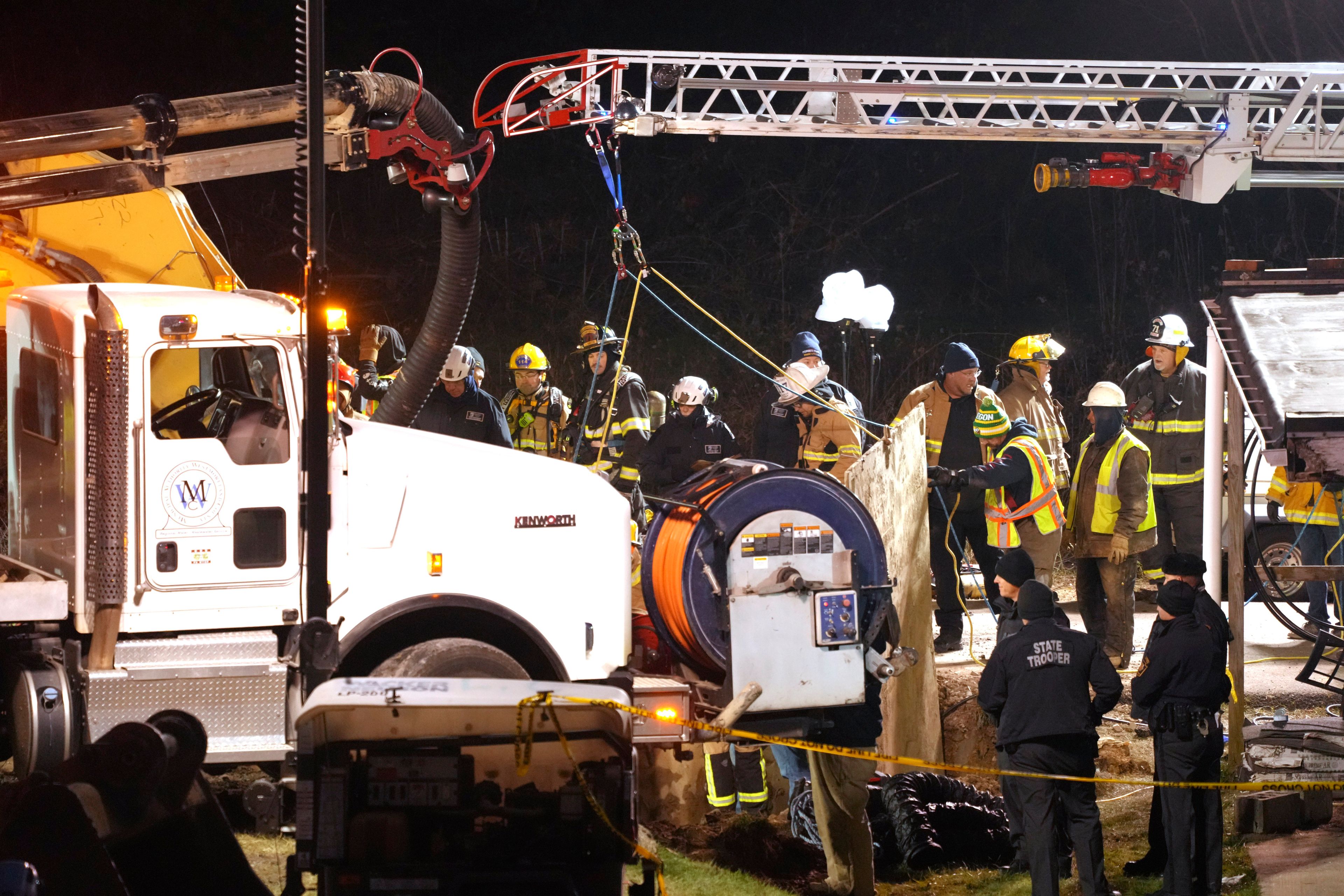 Rescue workers search in a sinkhole for Elizabeth Pollard, who disappeared while looking for her cat, in Marguerite, Pa., Tuesday, Dec. 3, 2024. (AP Photo/Gene J. Puskar)