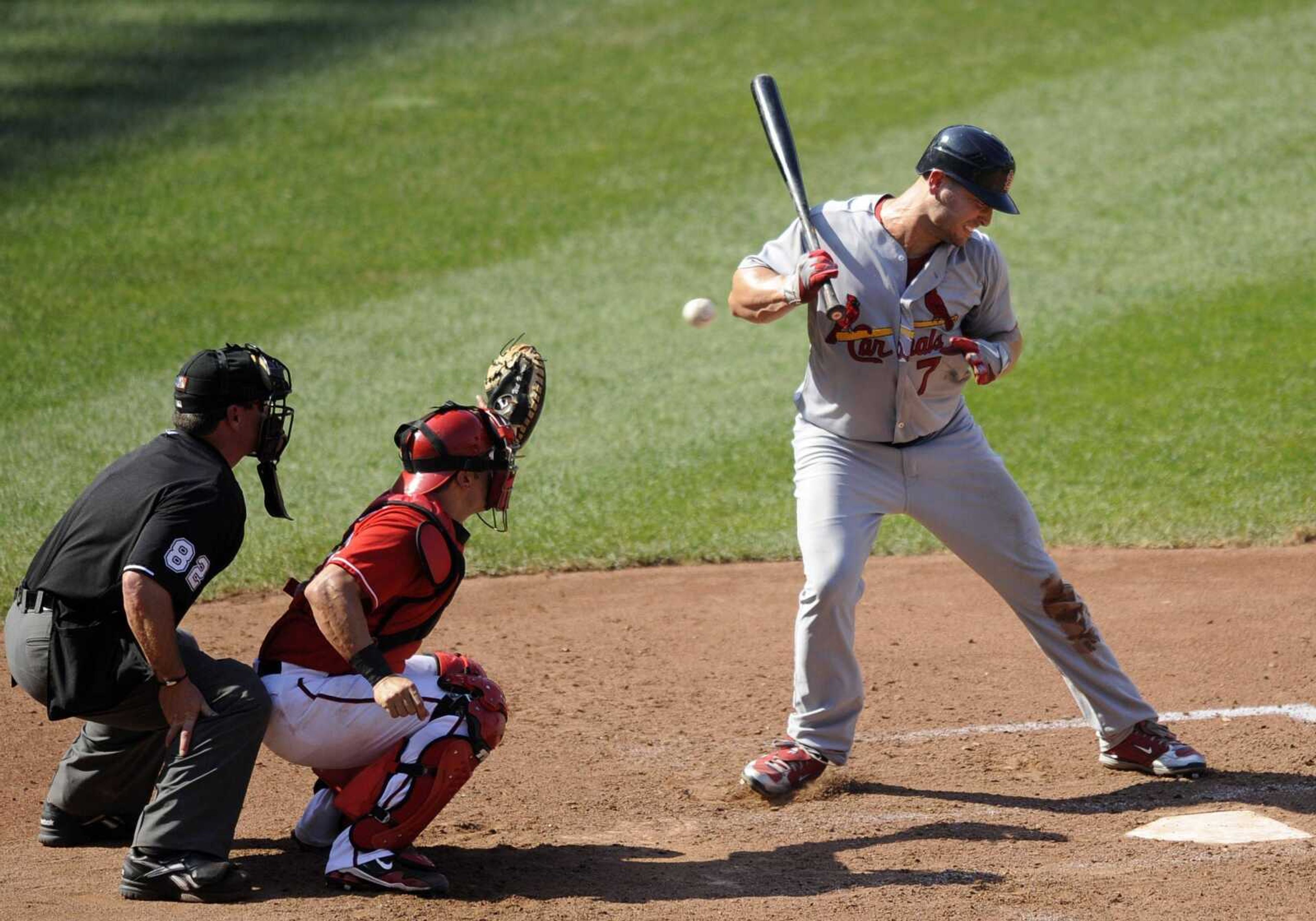 St. Louis Cardinals' Matt Holliday (7) reacts after he was almost hit by a pitch during the ninth inning of a baseball game as Washington Nationals catcher Wil Nieves, center, and home plate umpire Rob Drake (82) look on, Sunday, Aug. 29, 2010, in Washington. The Nationals won 4-2. (AP Photo/Nick Wass)