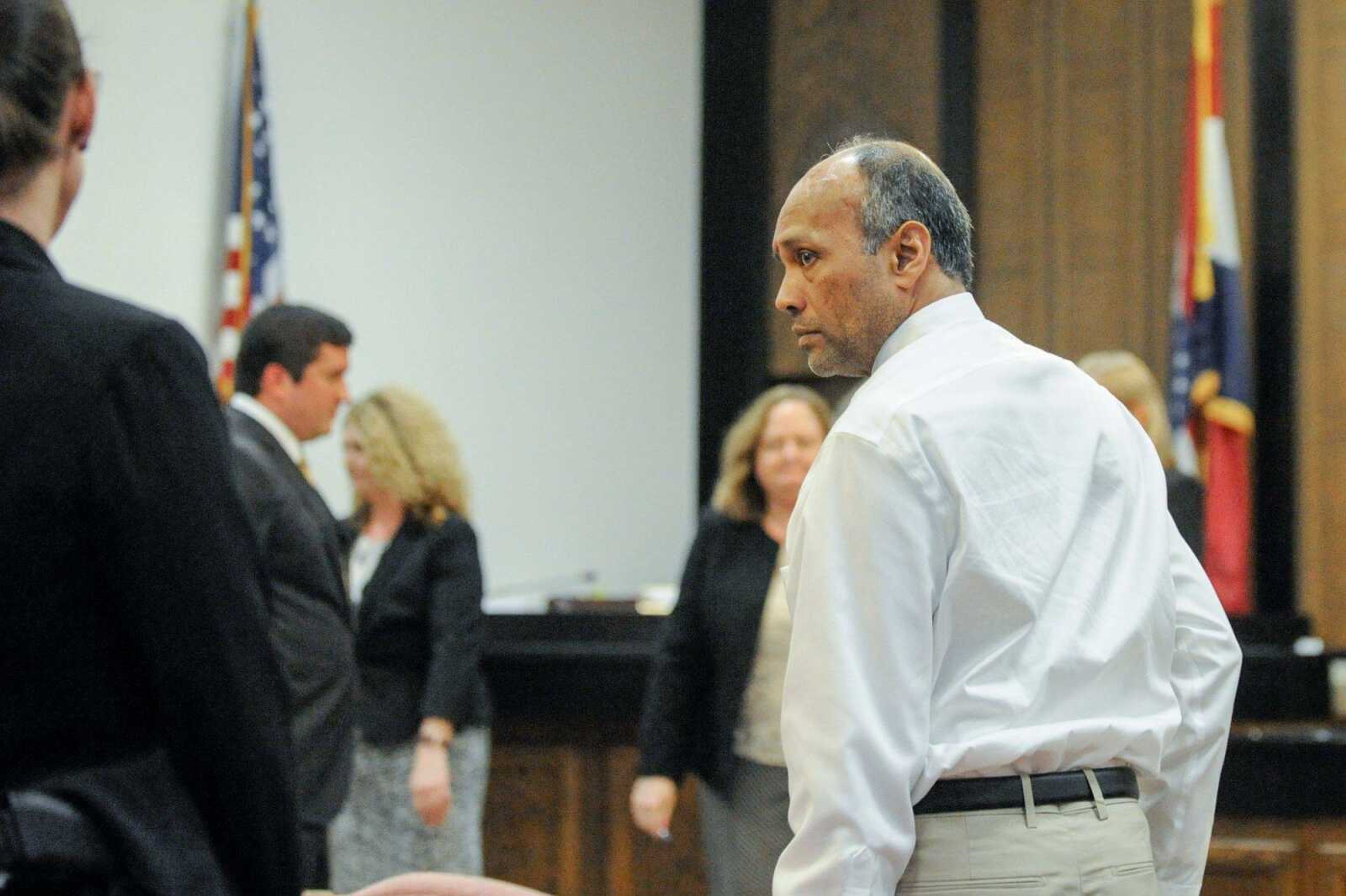 George Joseph looks back at his brother, Gerard, after being found guilty of two counts of first-degree murder for the shooting deaths of his wife and son. (Glenn Landberg)