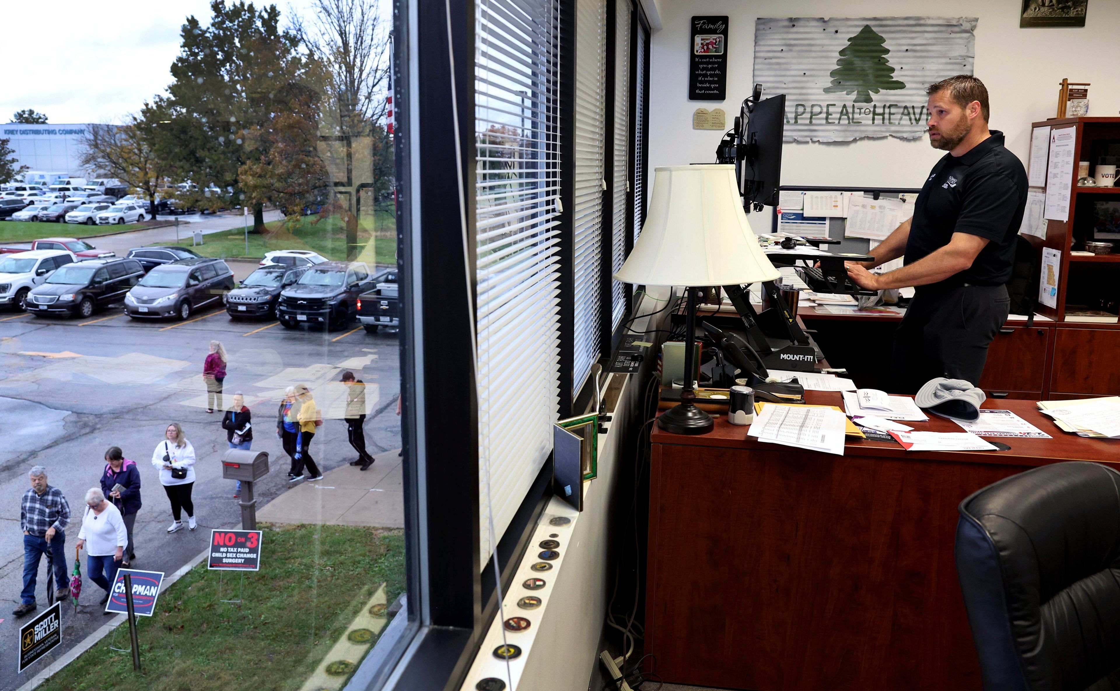 A line of early voters wraps around the election authority offices as St. Charles County Elections Director Kurt Bahr works in his office on Thursday, Oct. 31, 2024 in St. Peters, Mo. (Robert Cohen/St. Louis Post-Dispatch via AP)