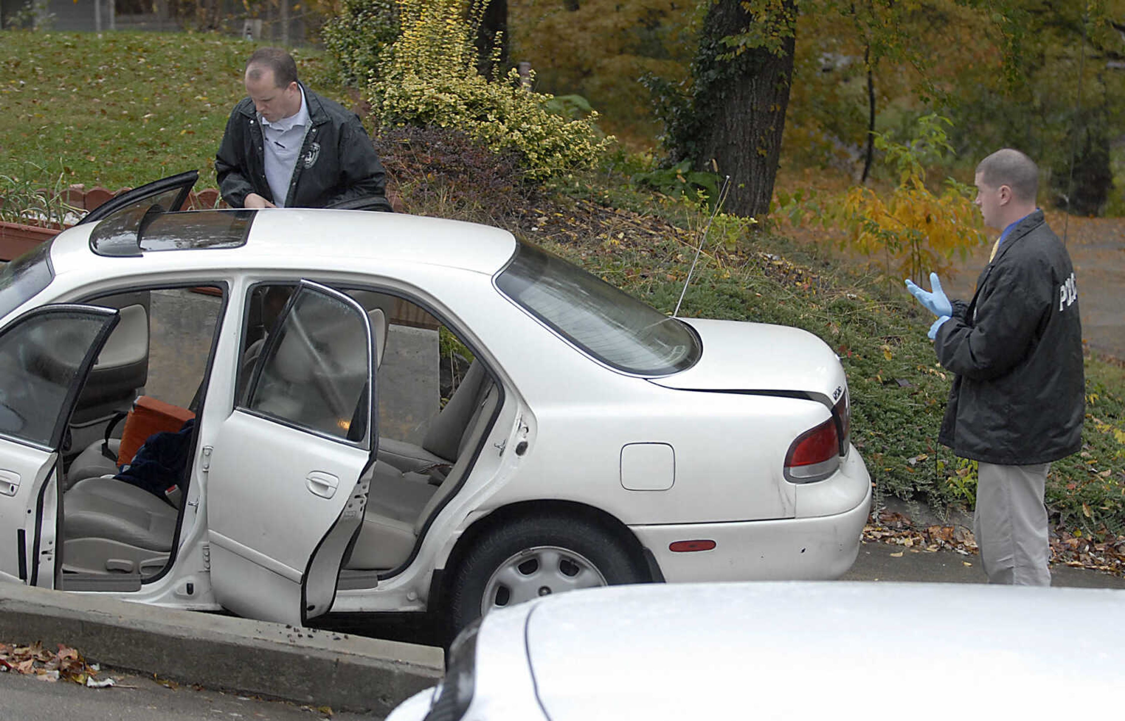 KIT DOYLE ~ kdoyle@semissourian.com
Jackson policemen Ryan Dooley and Justin Kemp investigate a white Mazda 626 across the street from 1224 N. Missouri St. Tuesday morning, October 27, 2009, in Cape Girardeau.