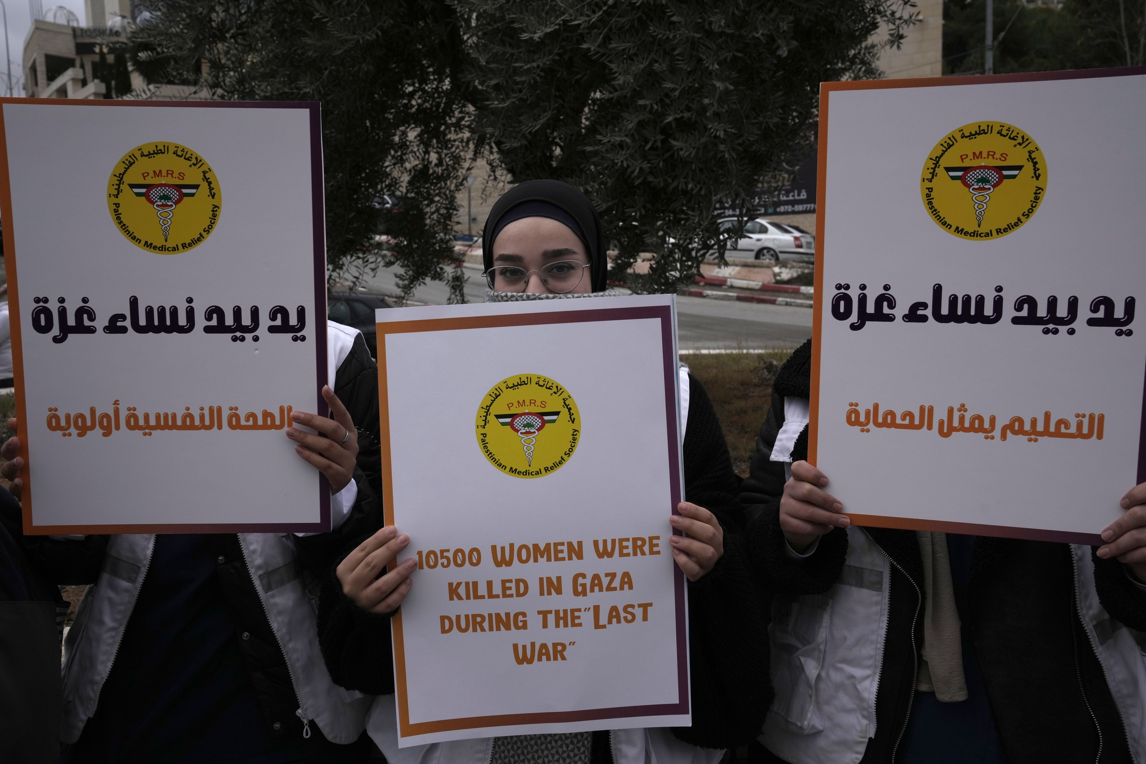 Members of the Palestinian Medical Relief Society mark the International Day for the Elimination of Violence Against Women, in the West Bank city of Bethlehem, Monday, Nov. 25, 2024. (AP Photo/Mahmoud Illean)