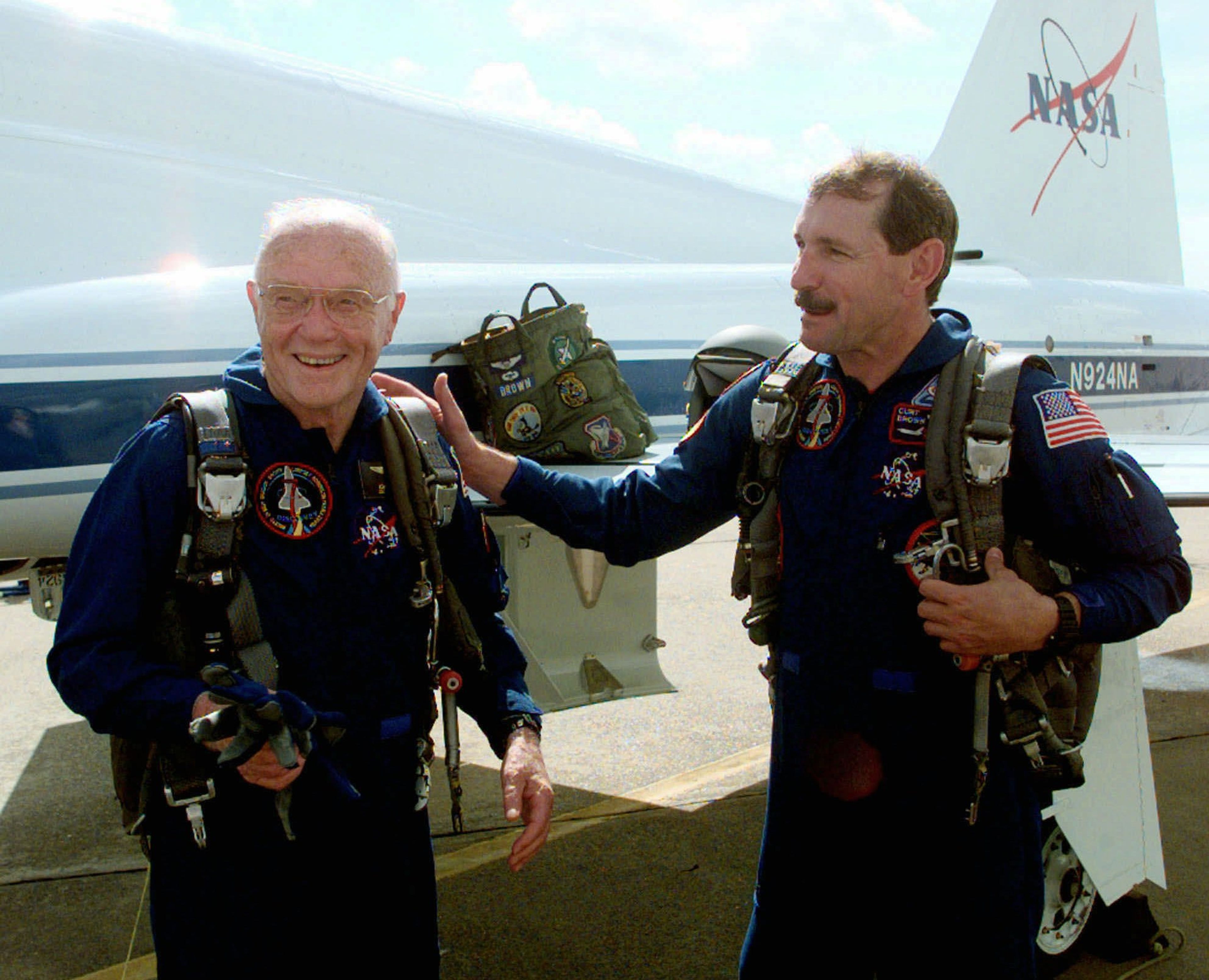 Astronaut Curt Brown, right, talks about Astronaut and Sen. John Glenn's, D-Ohio, performance after a training flight Monday, Aug. 24, 1998, in Houston. Brown and Glenn are members of the space shuttle crew scheduled to fly in October. 