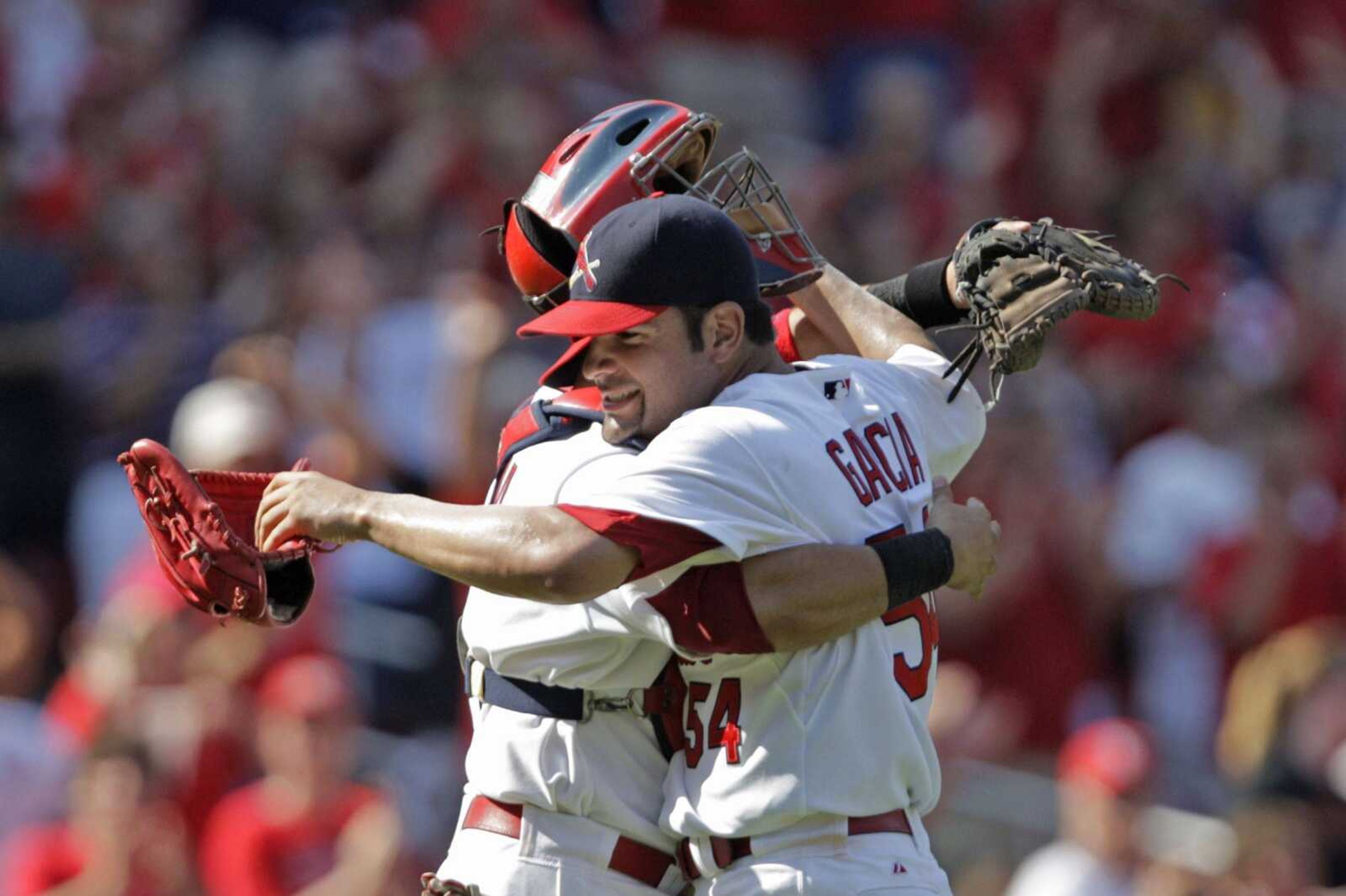 Cardinals pitcher Jaime Garcia receives a hug from catcher Yadier Molina after throwing his first career shutout Sunday against the Giants in St. Louis. (Tom Gannam ~ Associated Press)