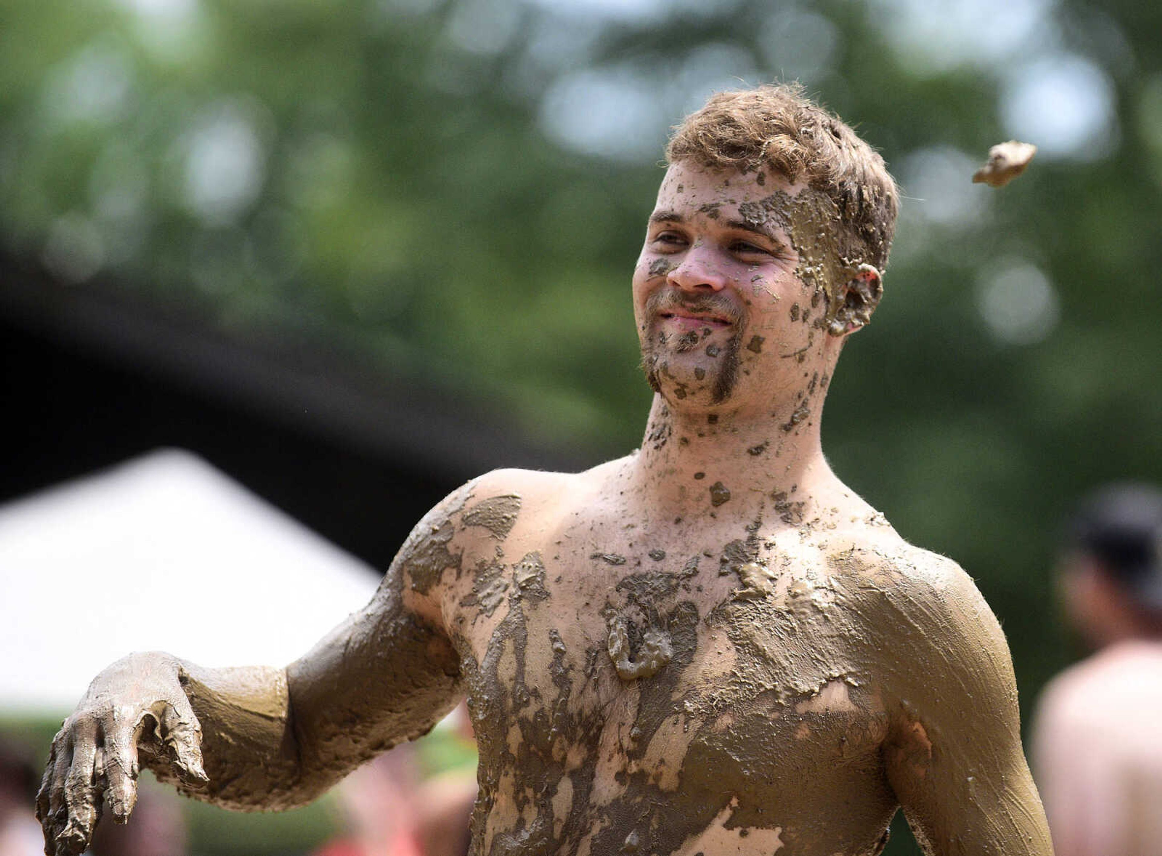 Mud covers team members as they play mud volleyball during the Fourth of July celebration on Tuesday at Jackson City Park.