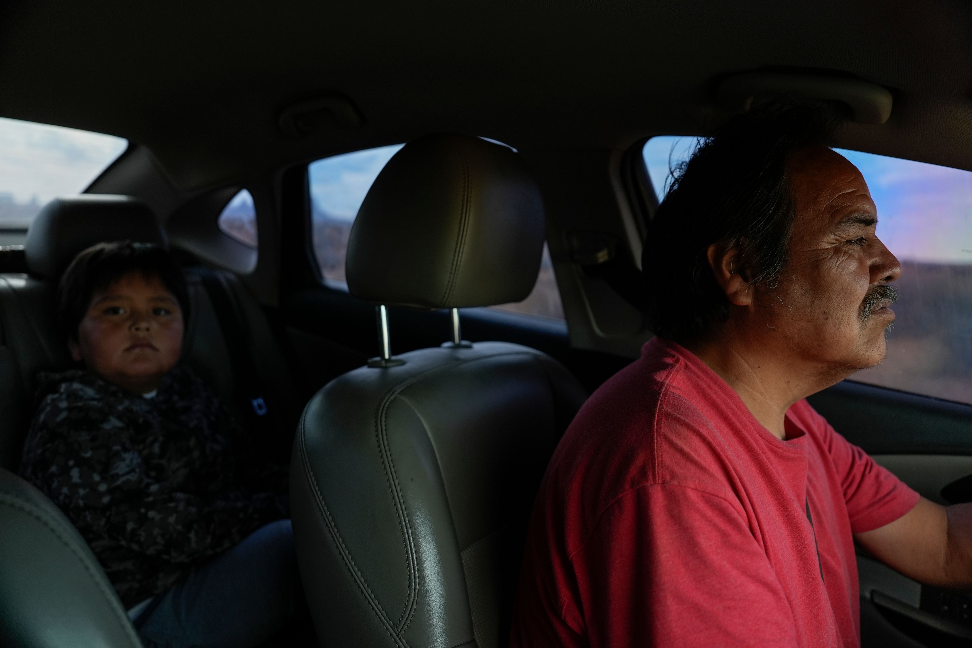 Ricky Gillis, right, drives his grandson, Liam, 7, left, back to their home after picking him up from the school bus stop, Tuesday, Oct. 8, 2024, on the Navajo Nation in Halchita, Utah. (AP Photo/Joshua A. Bickel)