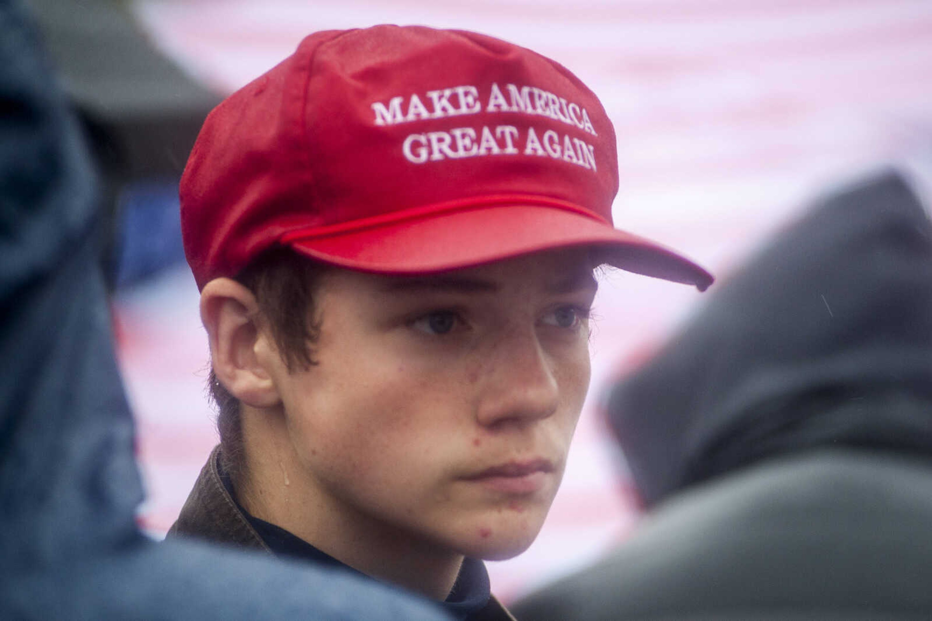 Dearmont Goodin, 14, of Charleston, Missouri, stands in line to attend a rally for President Trump at the Show Me Center Monday.