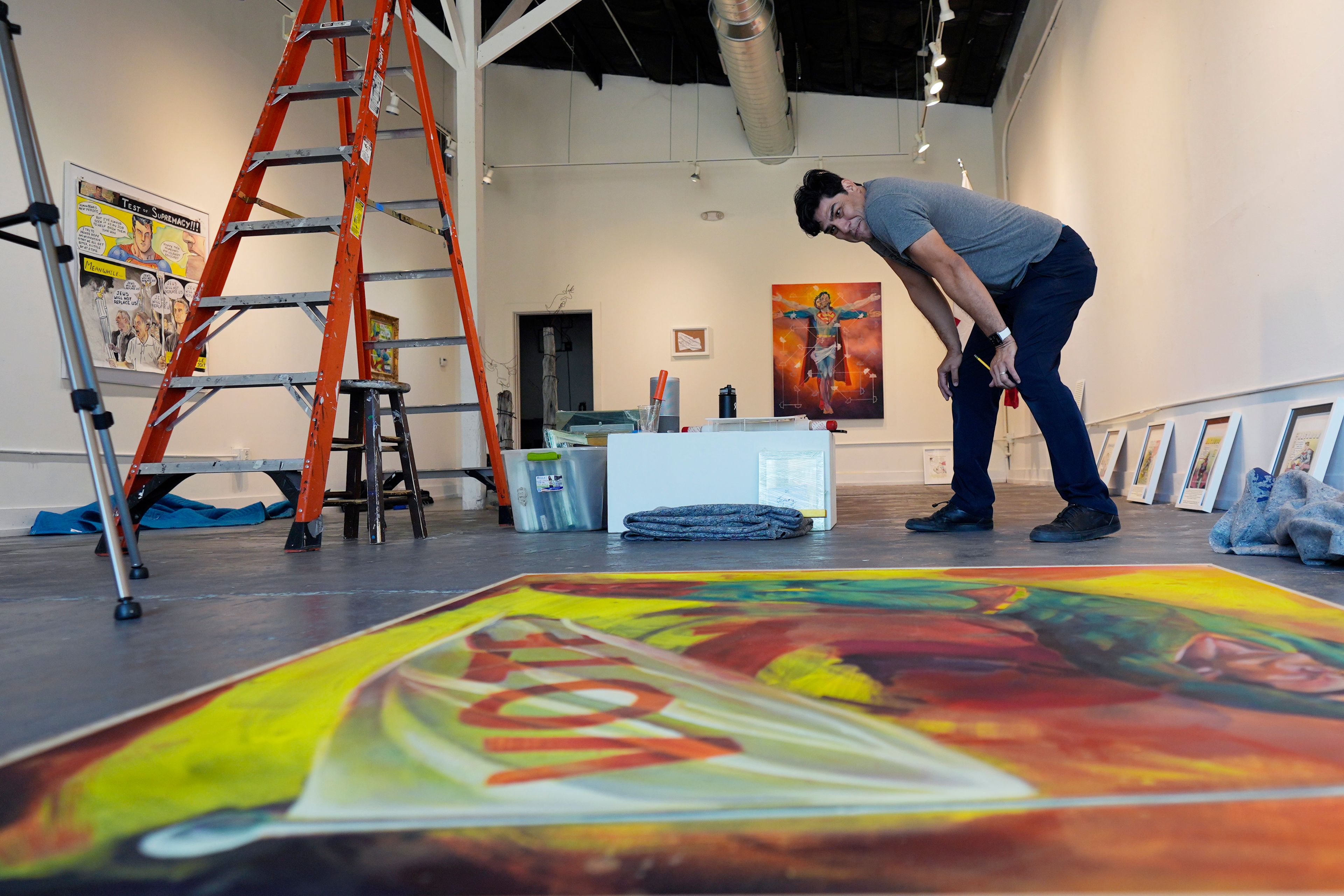 Artist David Alcantar prepares works of art from his "Superman Project" for an upcoming show in San Antonio, Tuesday, Oct. 1, 2024. (AP Photo/Eric Gay)