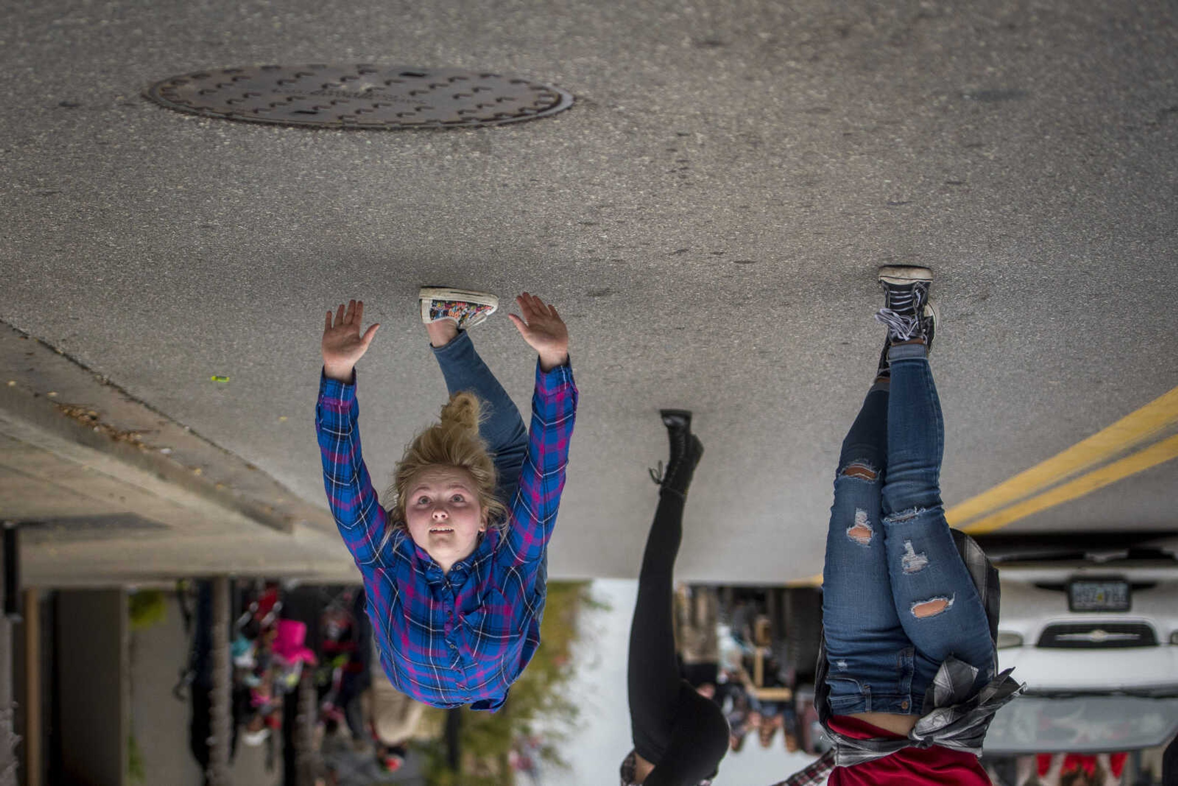 A woman performs a back handspring during the Southeast Missouri State University homecoming parade Saturday, Oct. 13, 2018.