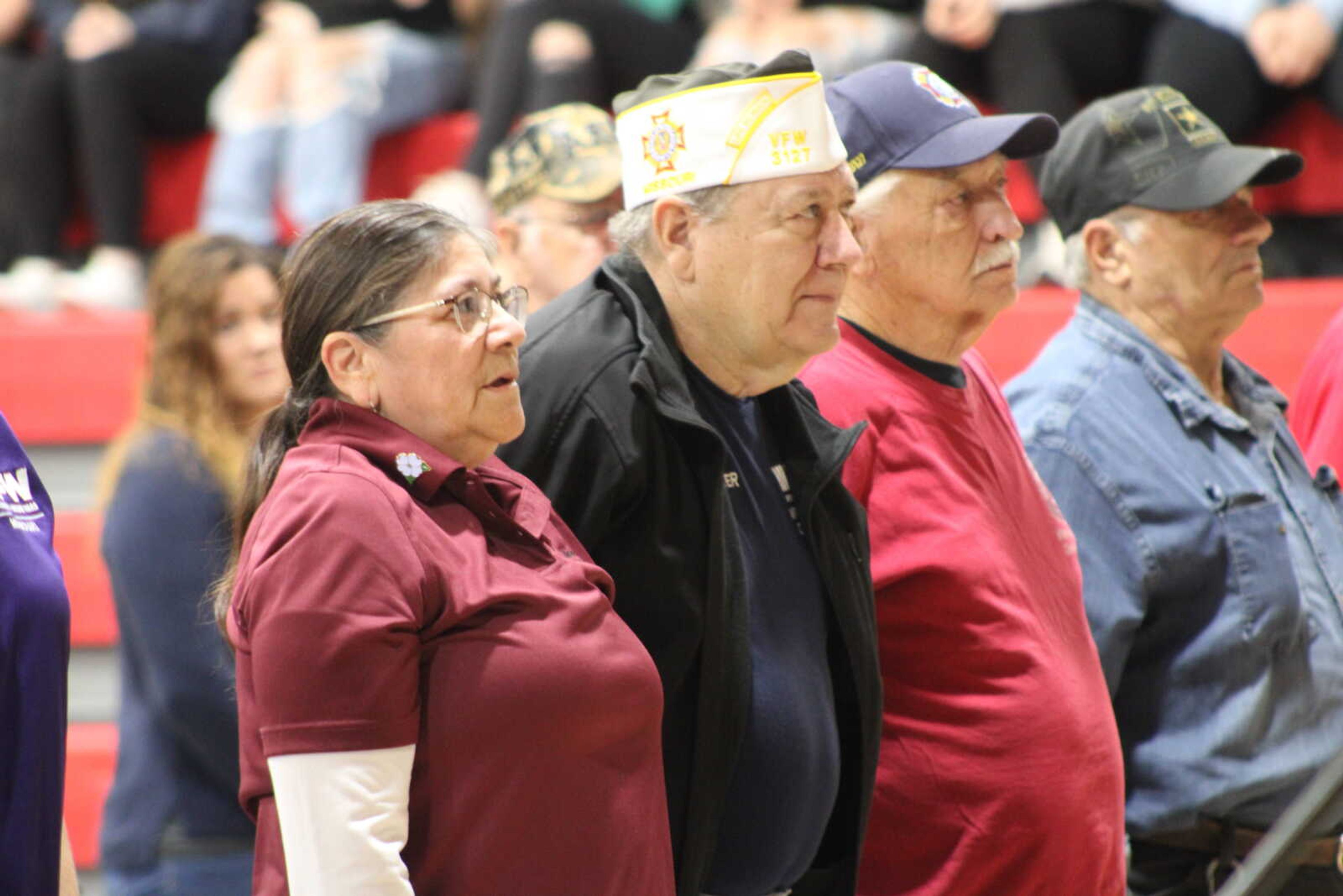 Veterans in attendee stand when their branch is called during the Armed Forces on Parade played by the Chaffee High school band.&nbsp;