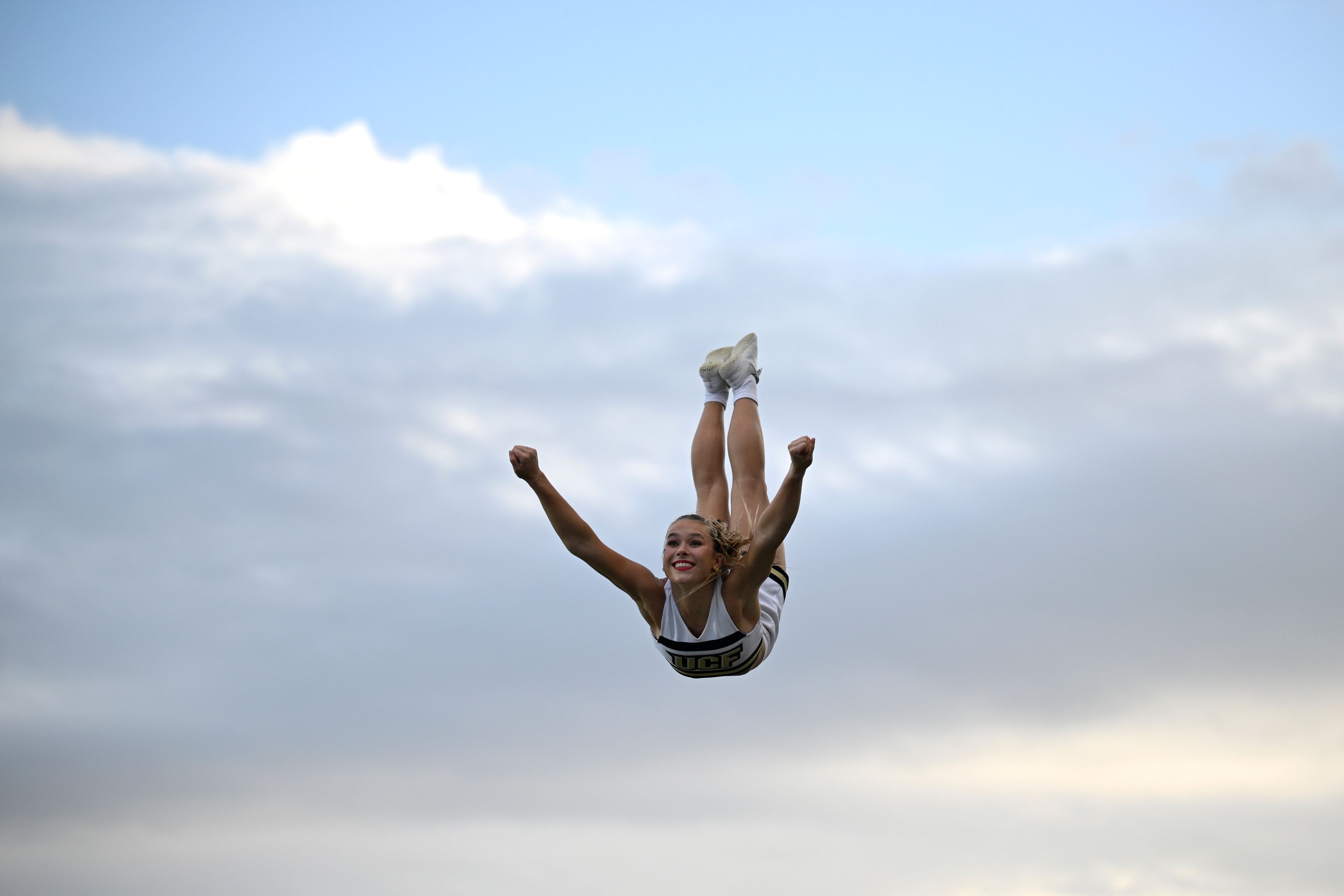 Central Florida cheerleaders perform on the field during the second half of an NCAA college football game against Cincinnati, Saturday, Oct. 12, 2024, in Orlando, Fla. (AP Photo/Phelan M. Ebenhack)