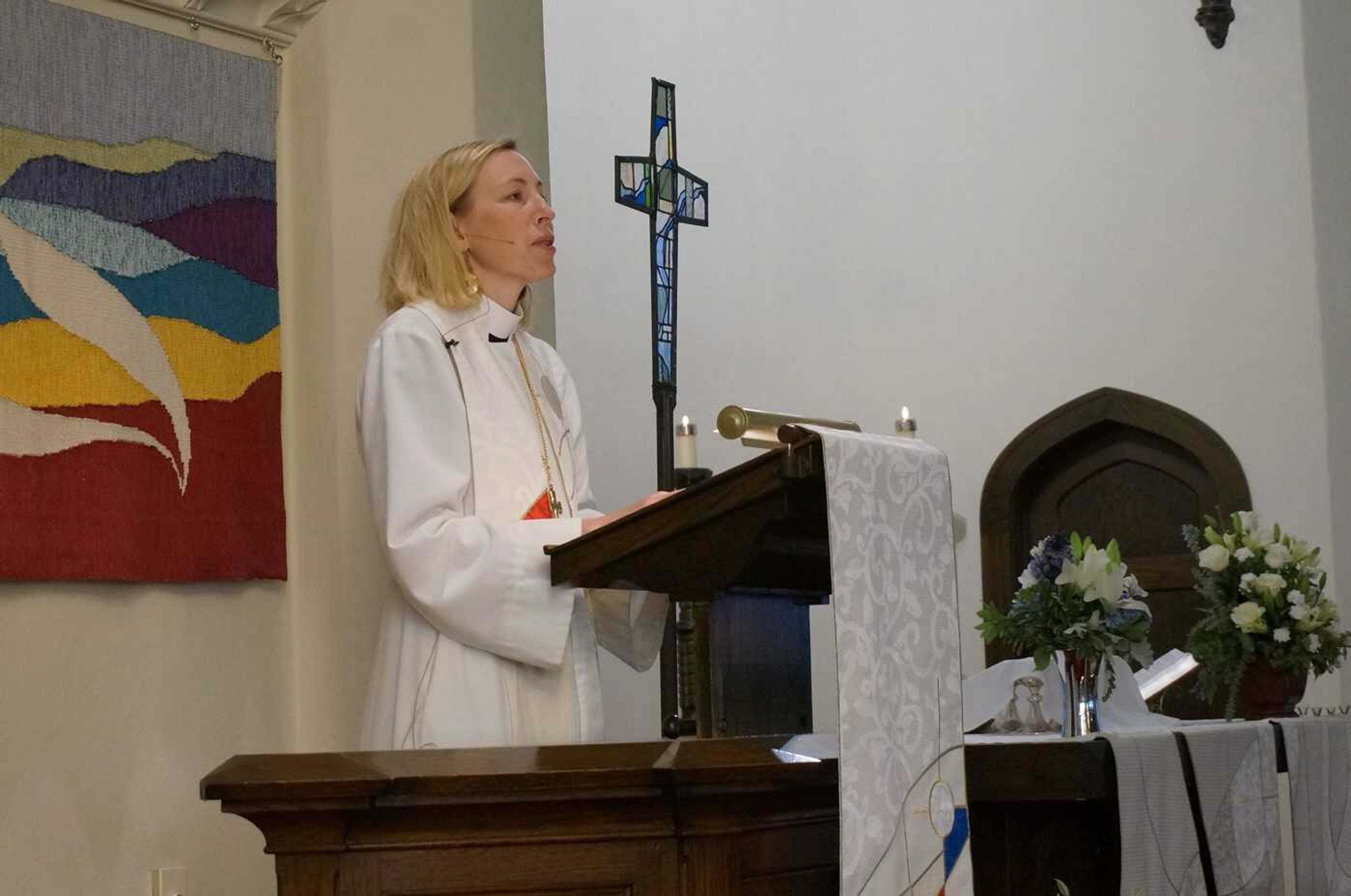 The Rev. Ingrid Rasmussen, pastor at Holy Trinity Lutheran Church in Minneapolis, preaches to her congregation during Sunday, Nov. 6, worship service. Faith leaders have squeezed in some final messages about the midterm elections during their weekend services and get out the vote events.