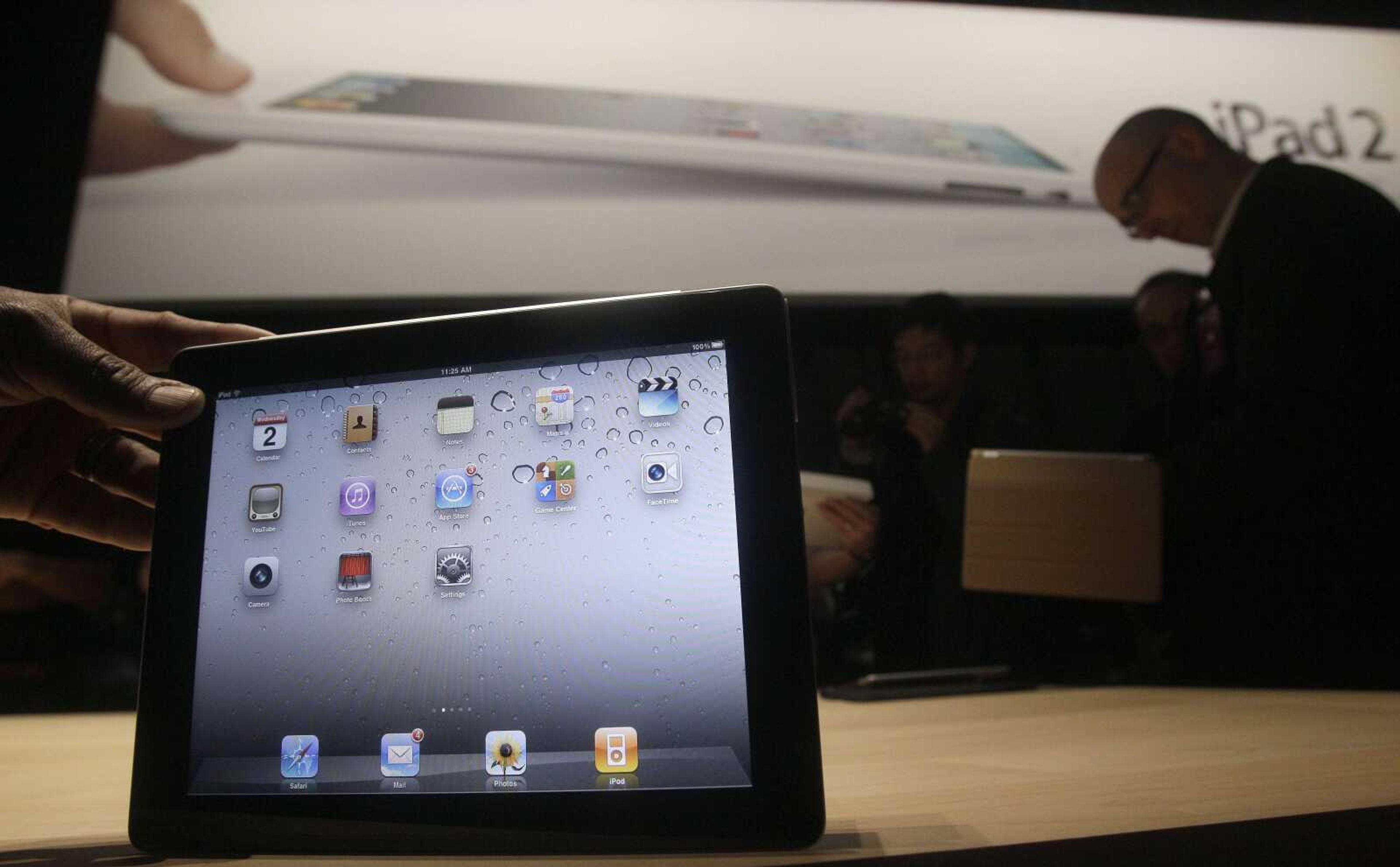 The iPad 2 is shown March 2 at an Apple event after the Yerba Buena Center for the Arts Theater in San Francisco. The new iPad model hitting stores today comes with several improvements but the same price tag as the original version. (Jeff Chiu ~ Associated Press)