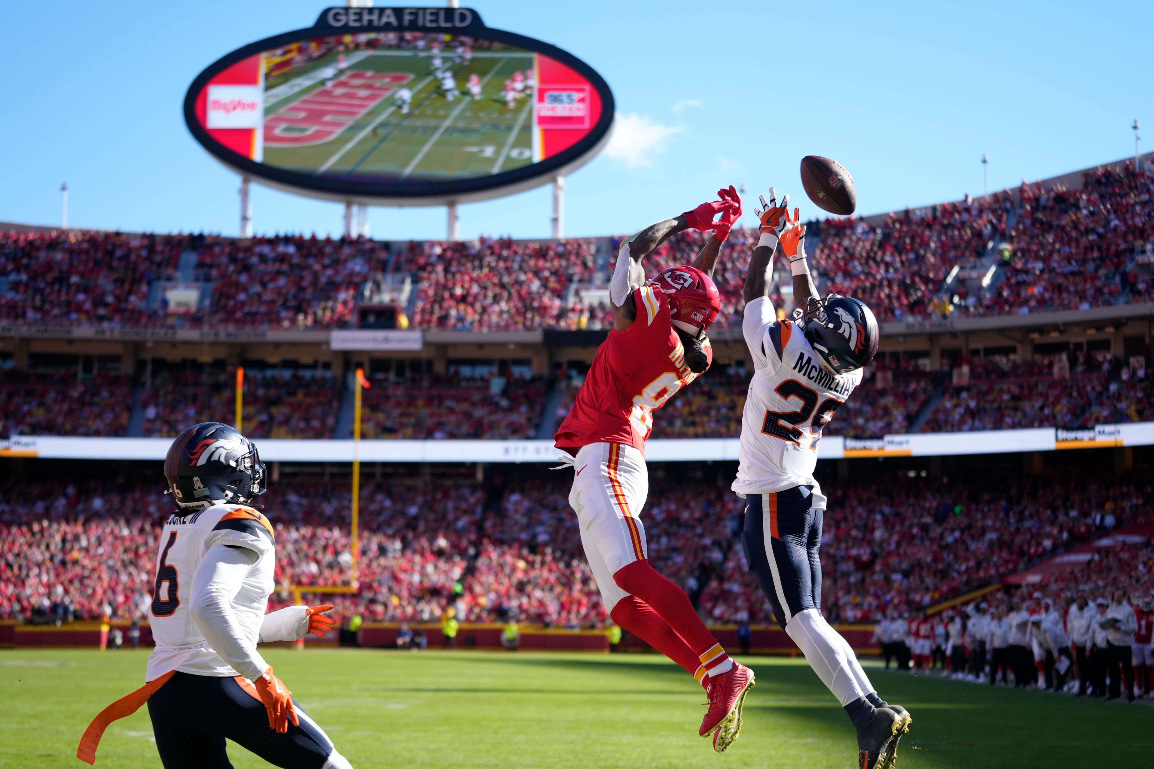 Kansas City Chiefs wide receiver DeAndre Hopkins (8) is unable to catch a pass as Denver Broncos cornerback Ja'Quan McMillian (29) and safety P.J. Locke (6) defend during the first half of an NFL football game Sunday, Nov. 10, 2024, in Kansas City, Mo. (AP Photo/Ed Zurga)