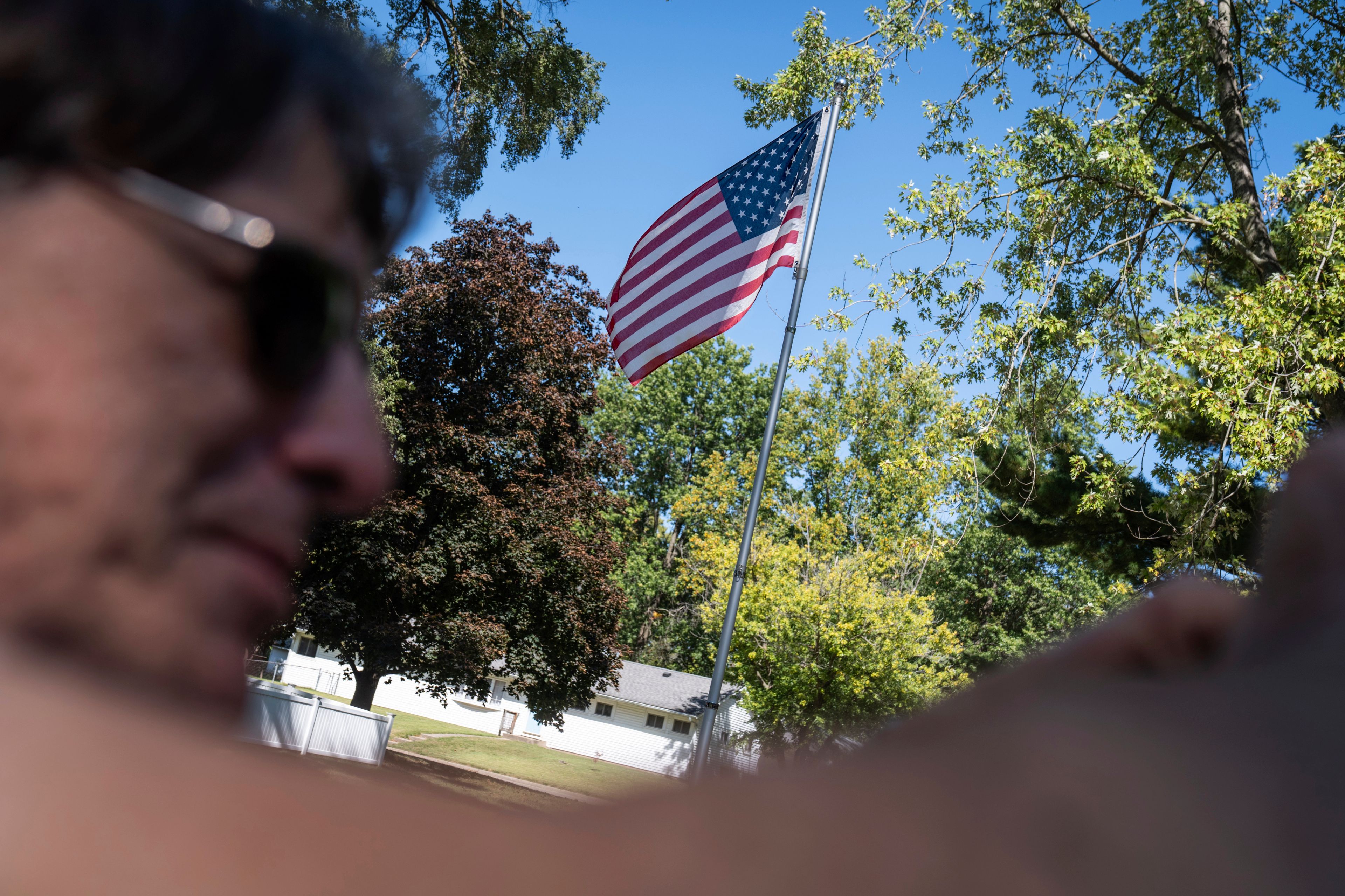 An American flag flies outside the home Matt Dzik shares with his wife, Lesley, in Champaign, Ill., Saturday, Sept. 21, 2024. "The country is flawed but it's a national symbol that transcends all our differences," said Matt. (AP Photo/David Goldman)