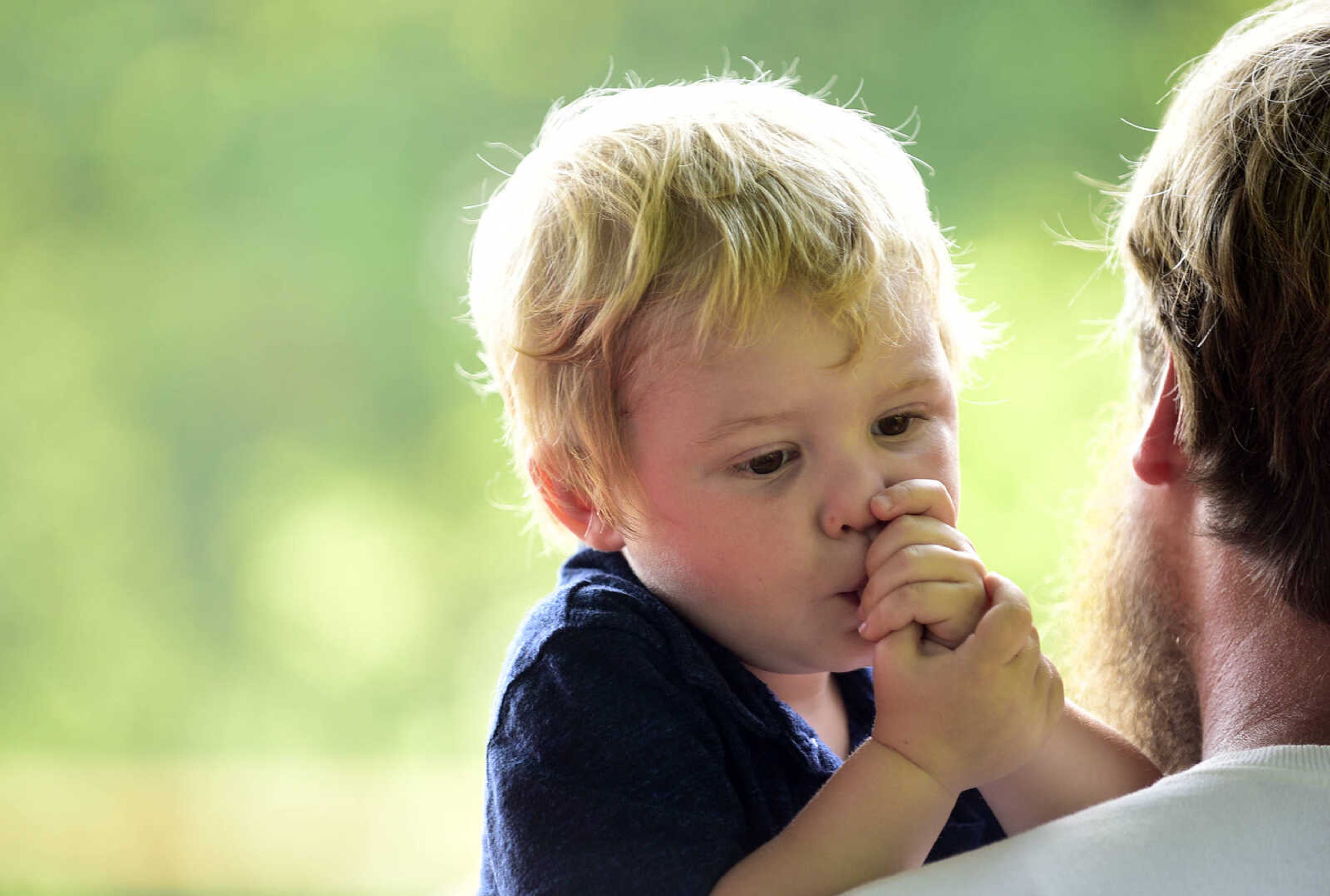 Rhett McCormack rests on his father's shoulder during the Fourth of July celebration on Tuesday at Jackson City Park.