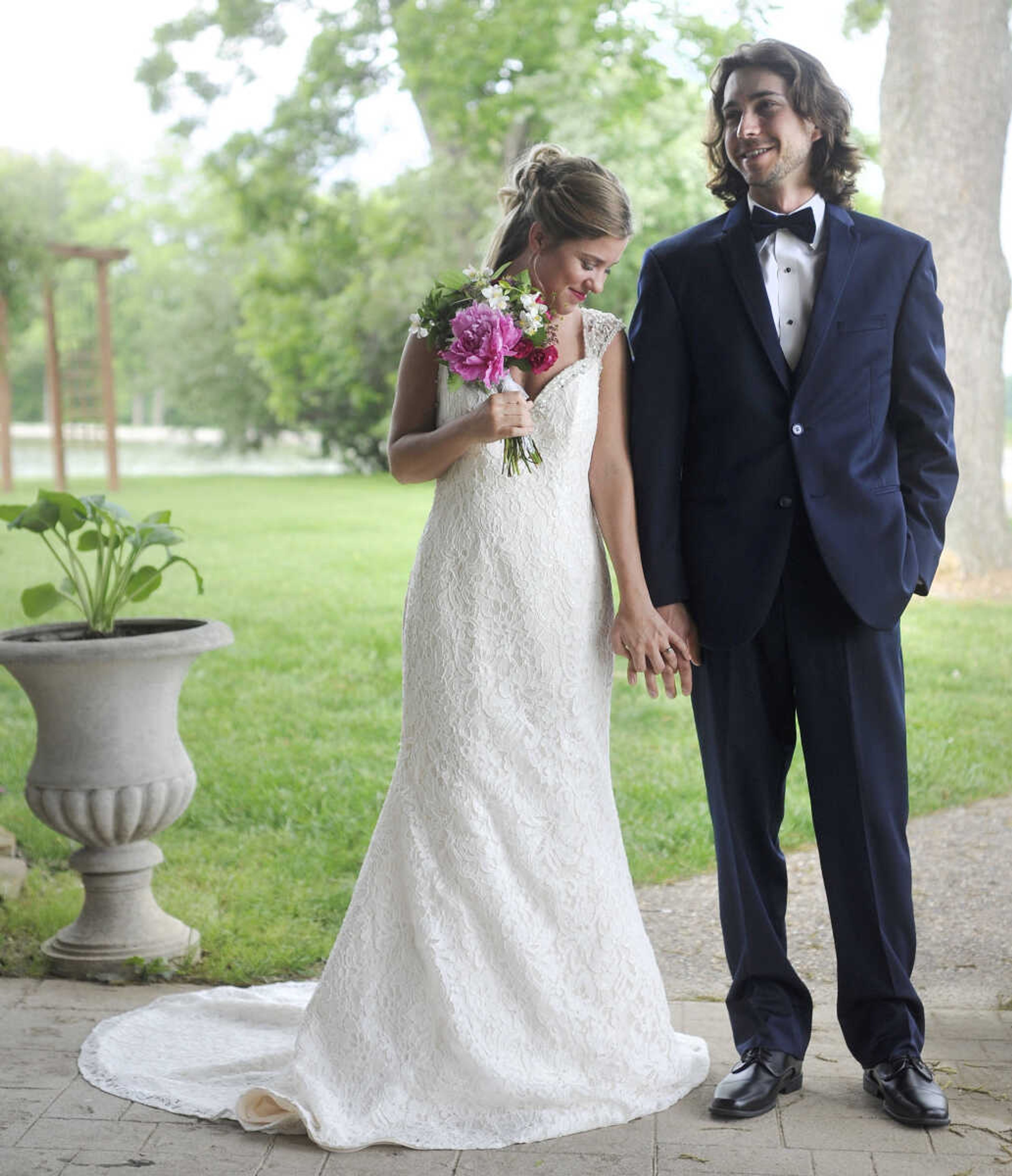 On Lydia:  Alfred Angelo fit-and-flare gown in ivory and champagne lace with crystal and rhinestone buttons adorning a sheer back. Available at Weddings and Parties Complete in Jackson.


On Evan: Navy Sterling slim fit wedding suit by Michael Kors with navy plaid bow tie. Provided by Jim's Formal Wear and available at Garber's Men's Wear in Cape Girardeau.